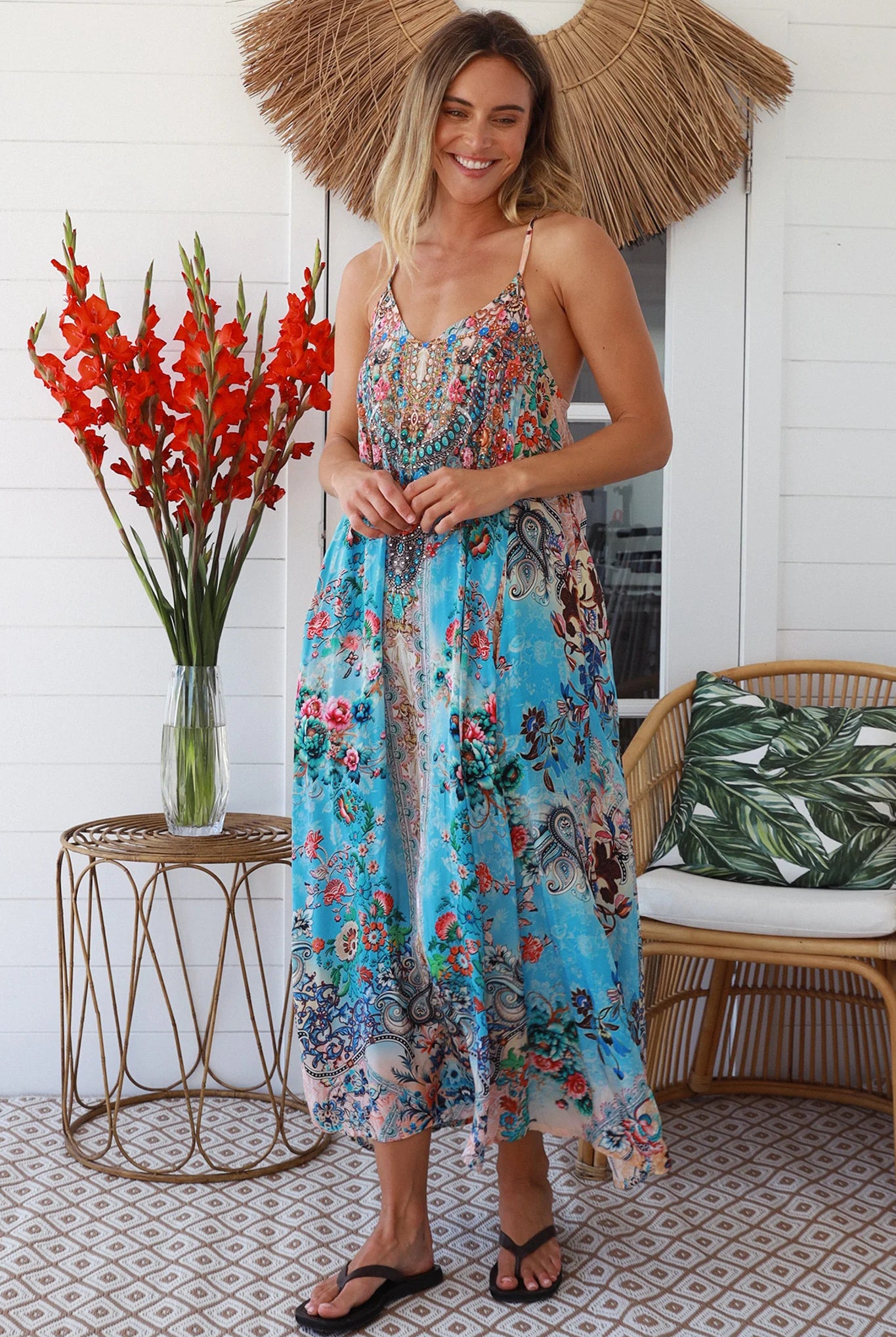 Woman wearing turquoise blue floral resort luxe midi dress with racerback straps - boho resort wear Australia