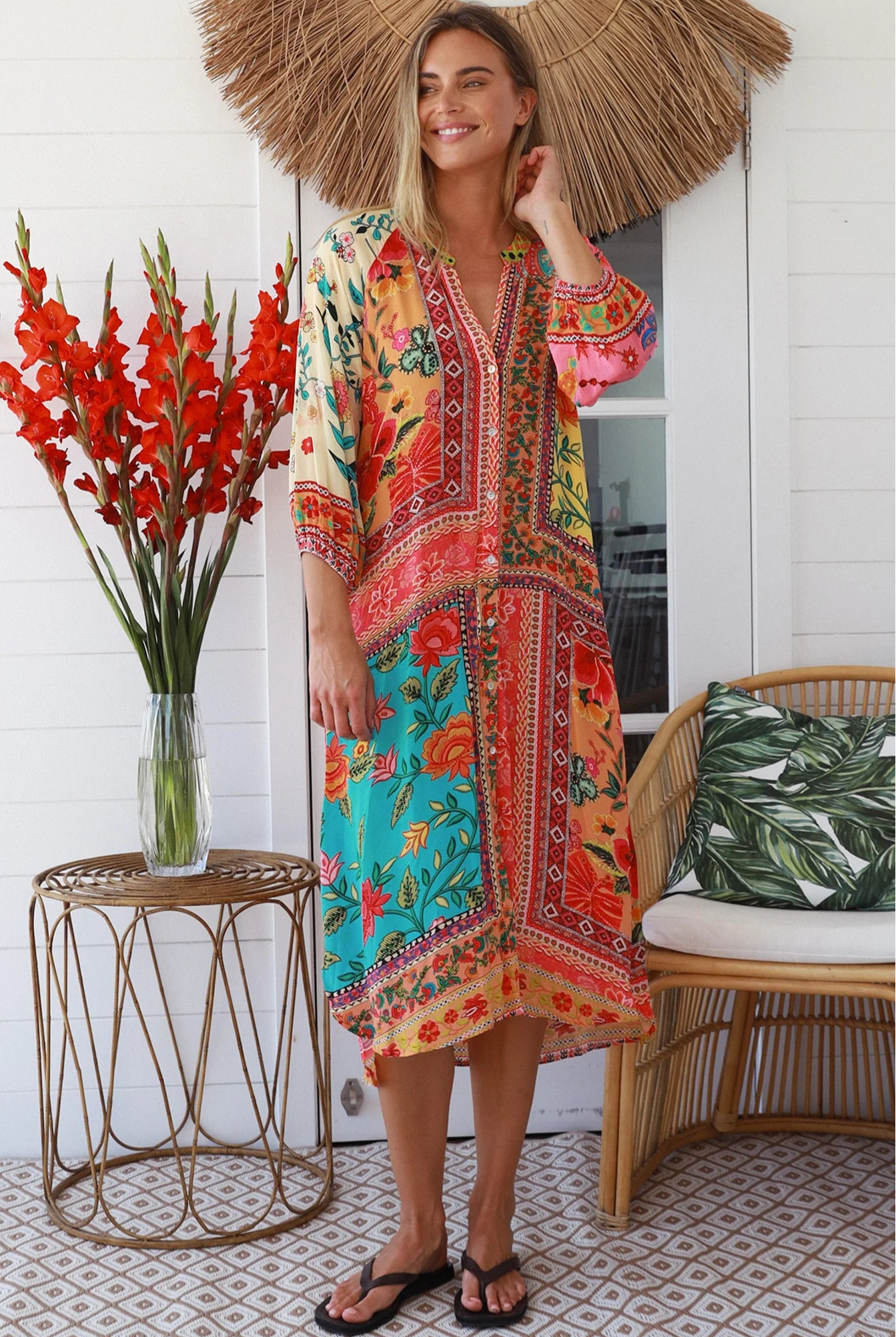 Woman in a colourful viscose-crepe boho patchwork midi dress with v-neck collar, button front & 3/4 sleeves.