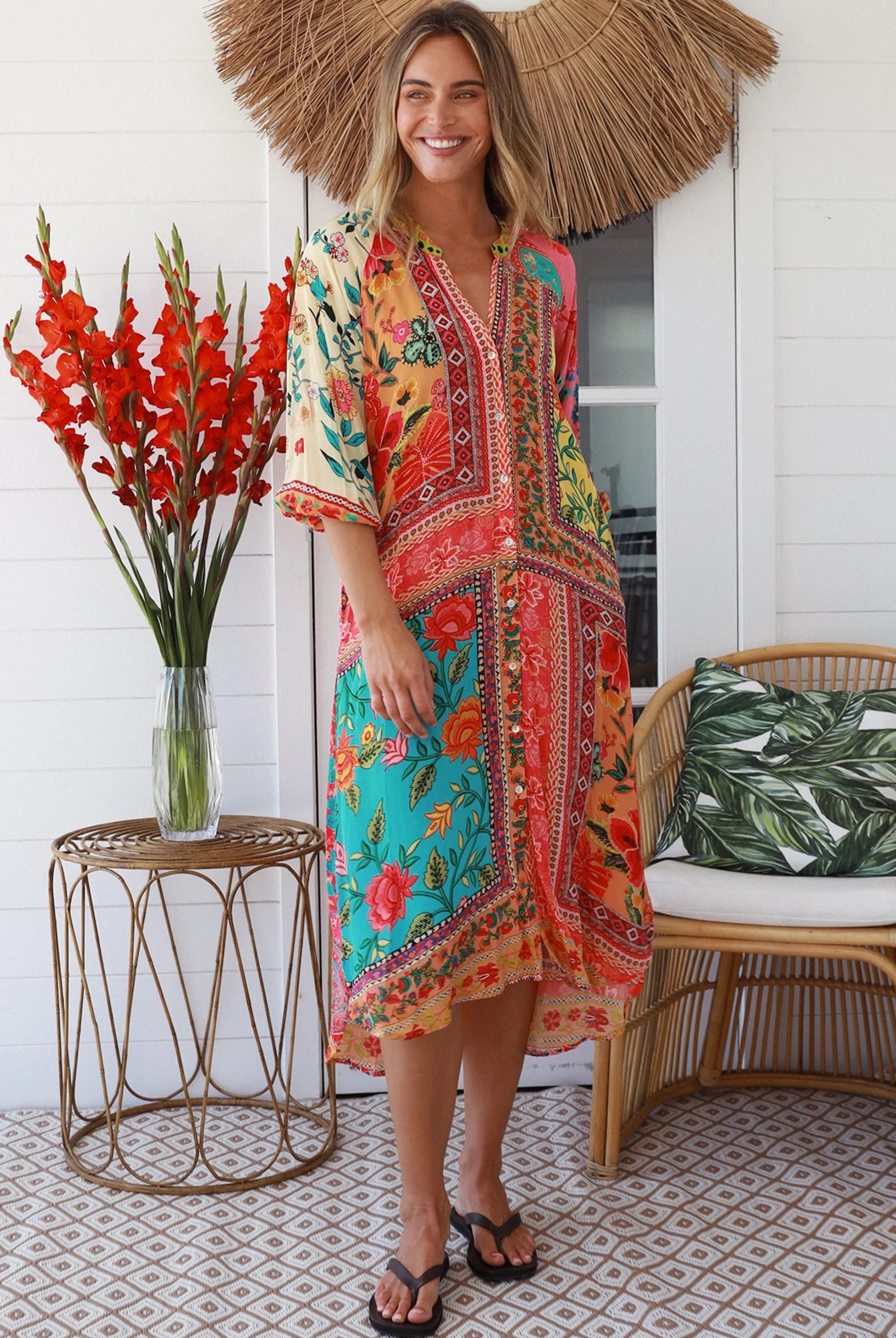 Woman in a colourful viscose-crepe boho patchwork midi dress with v-neck collar, button front & 3/4 sleeves.