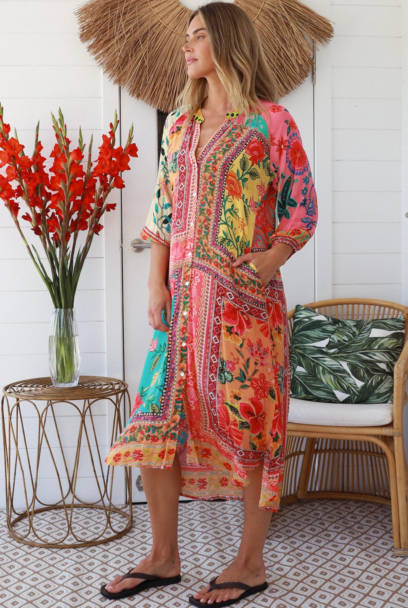 Woman in a colourful viscose-crepe boho patchwork midi dress with v-neck collar, button front & 3/4 sleeves.