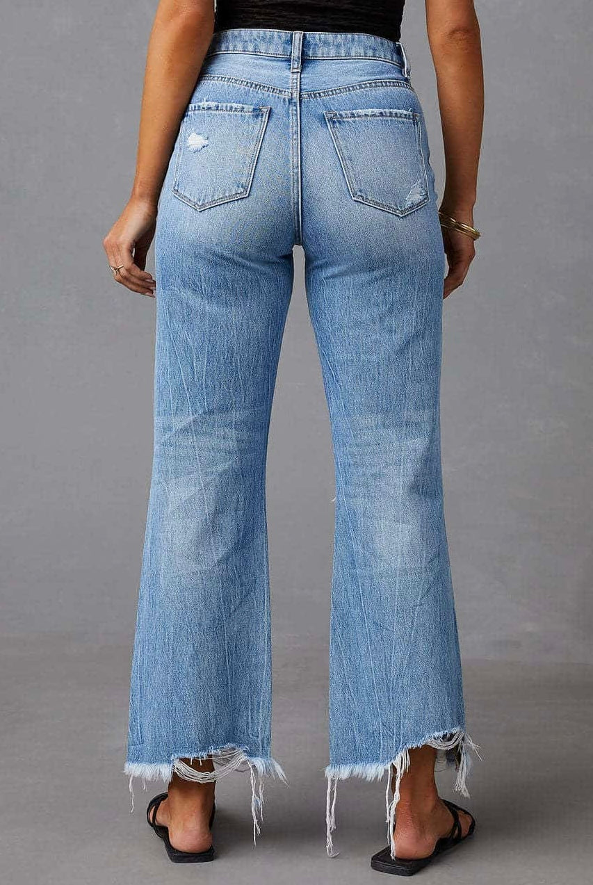 Woman wearing high-waisted light blue wide-leg jeans with raw hem and black tank - boho denim jeans Australia.