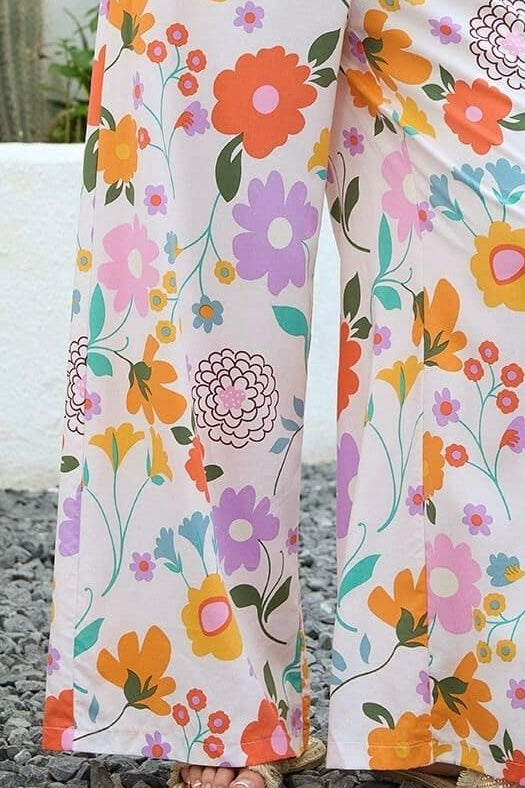 Vintage floral wide-leg pants with elastic waist and soft pastel print in a relaxed boho silhouette