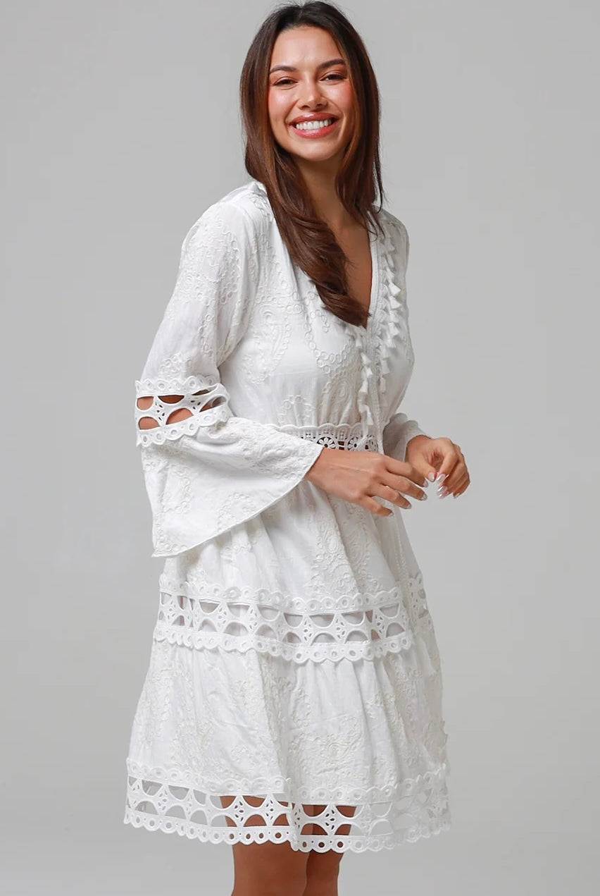 Woman in white embroidered cotton mini dress wit lace sleeves and tiered hem - Sabrina Mini Dress Bohemian Love Runway