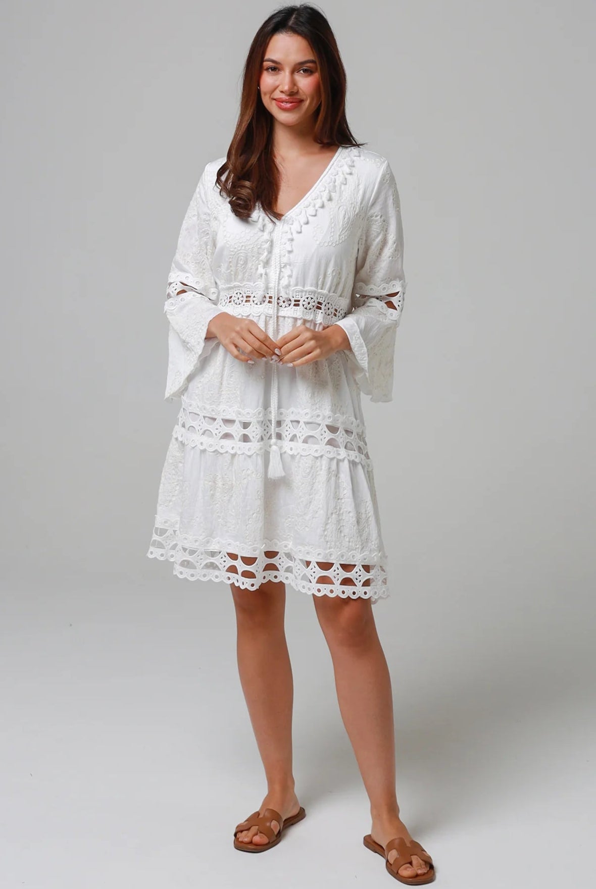Woman in white embroidered cotton mini dress wit lace sleeves and tiered hem - Sabrina Mini Dress Bohemian Love Runway