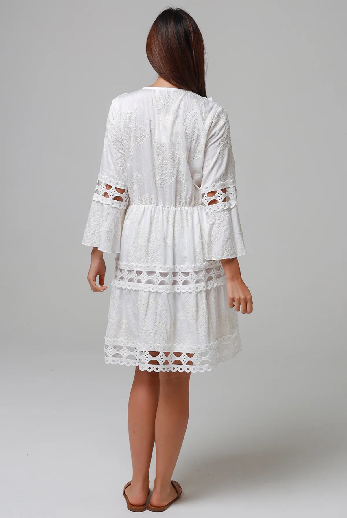 Woman in white embroidered cotton mini dress wit lace sleeves and tiered hem - Sabrina Mini Dress Bohemian Love Runway