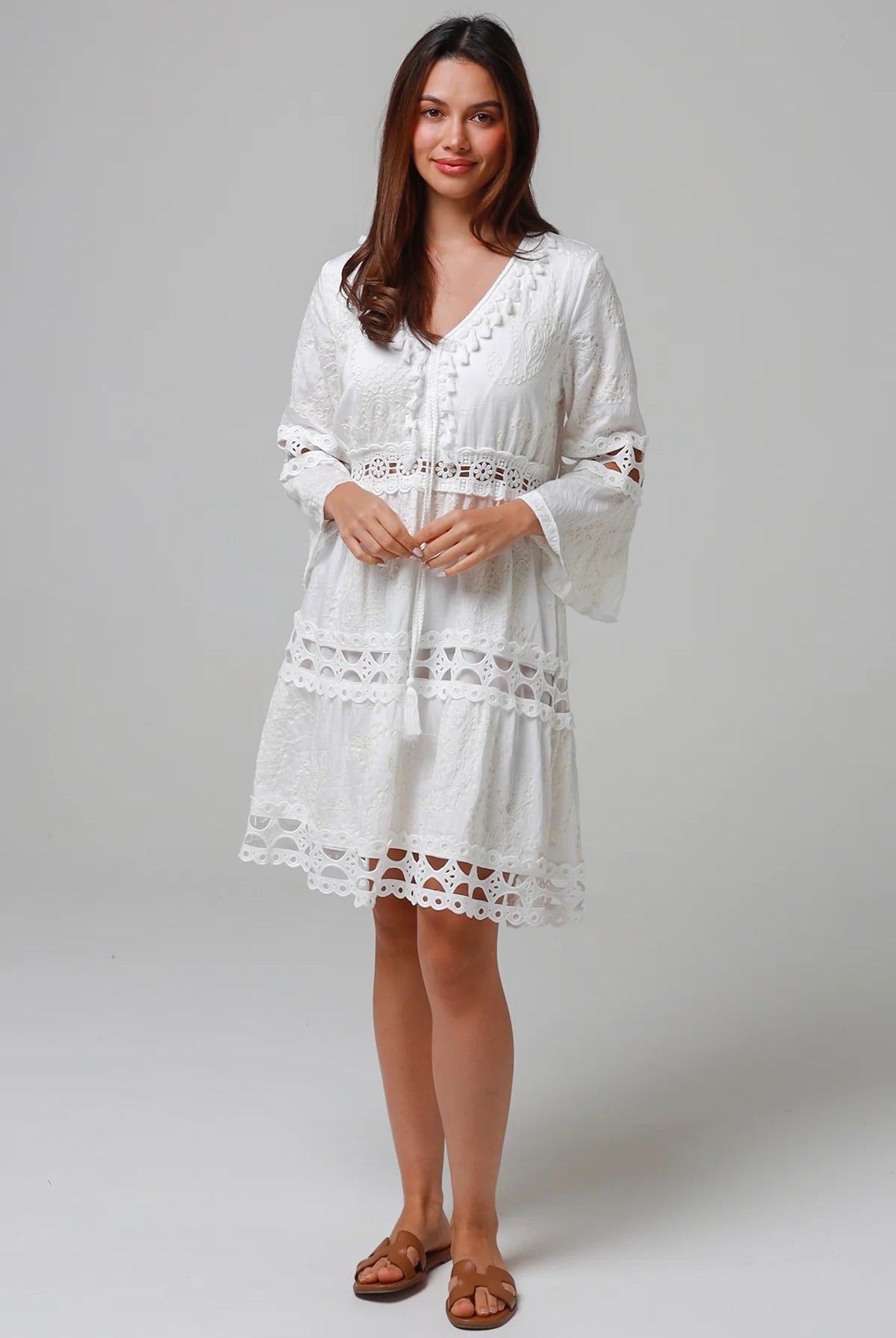 Woman in white embroidered cotton mini dress wit lace sleeves and tiered hem - Sabrina Mini Dress Bohemian Love Runway