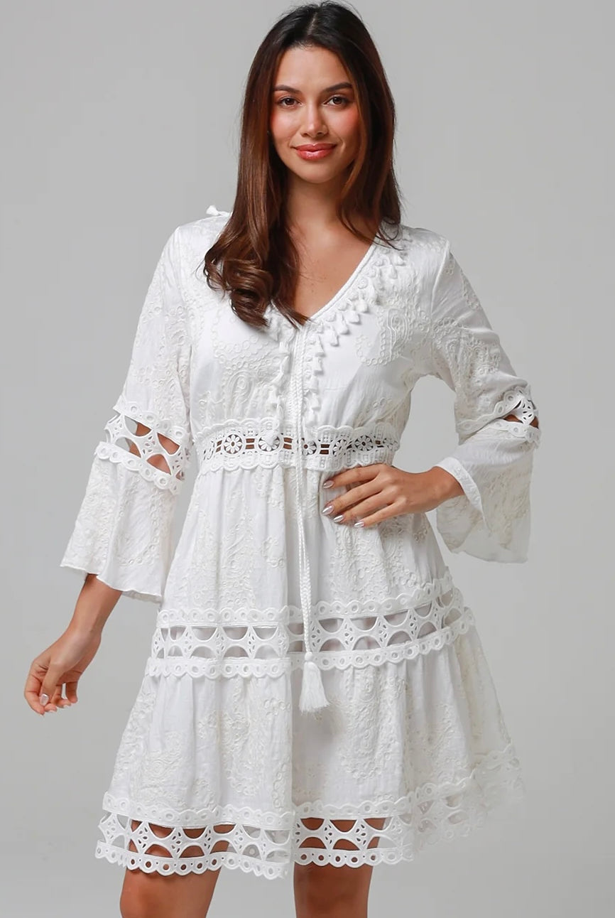 Woman in white embroidered cotton mini dress wit lace sleeves and tiered hem - Sabrina Mini Dress Bohemian Love Runway