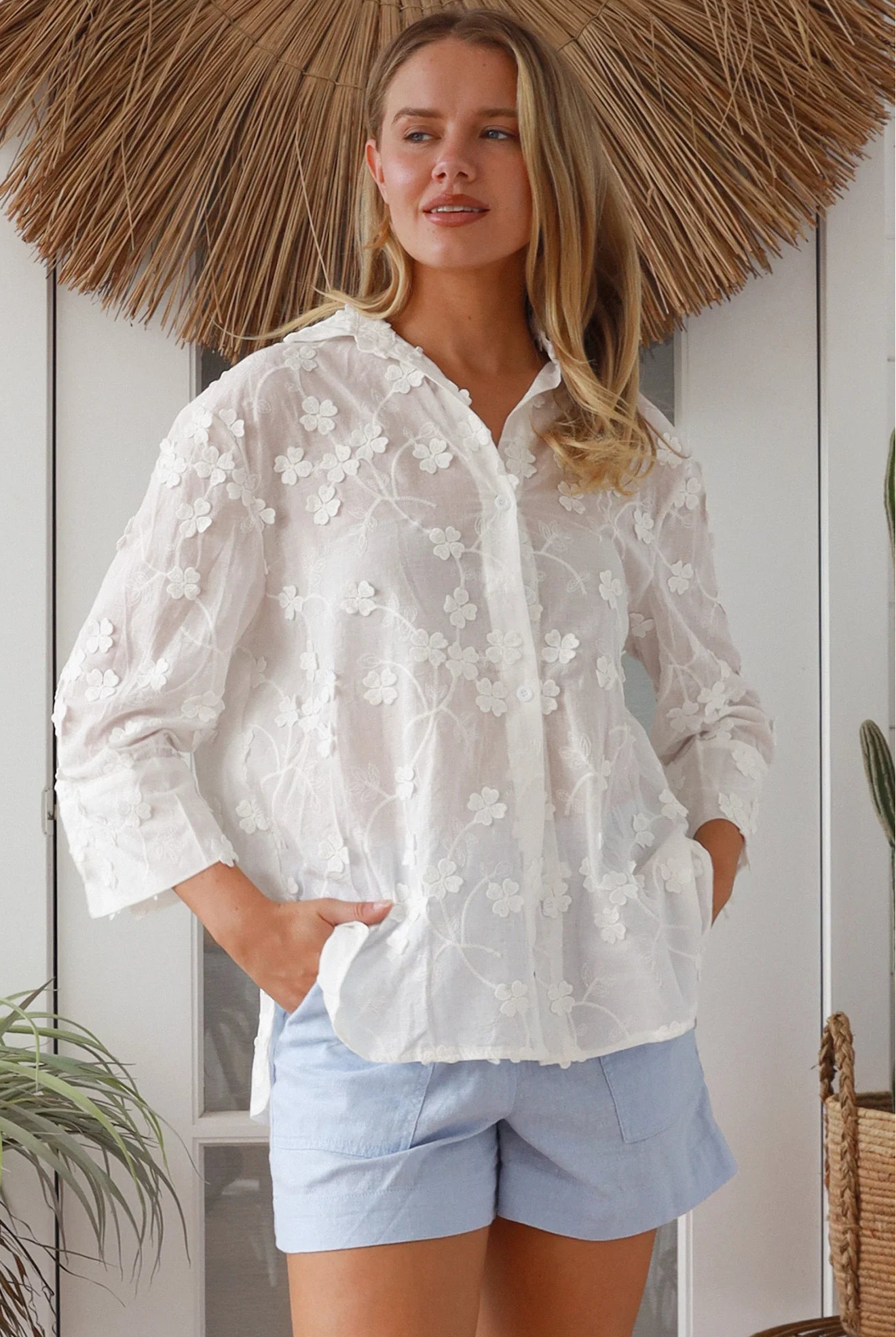 “Woman in white embroidered cotton button-down shirt with floral detailing – boho shirts Australia”