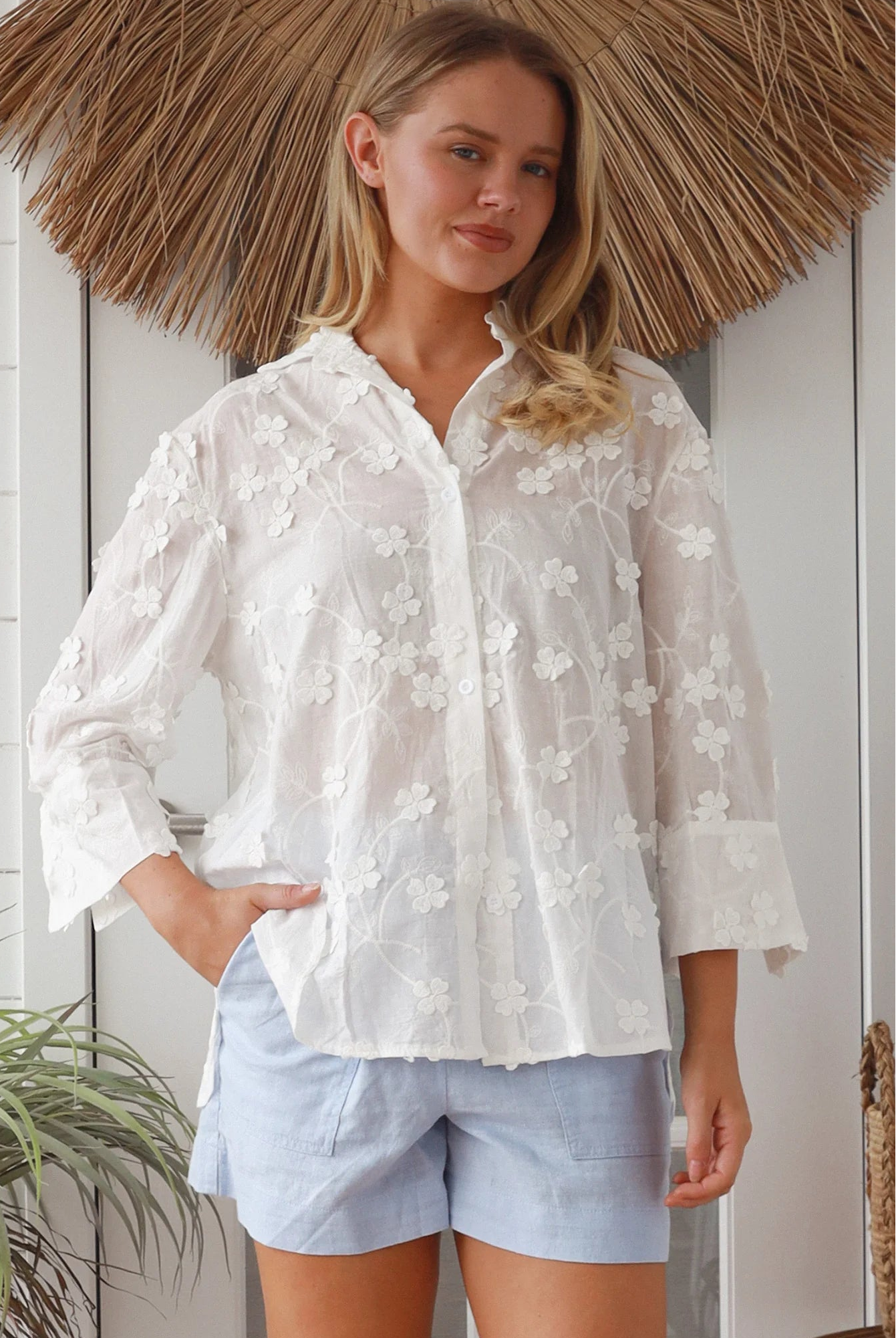 “Woman in white embroidered cotton button-down shirt with floral detailing – boho shirts Australia”