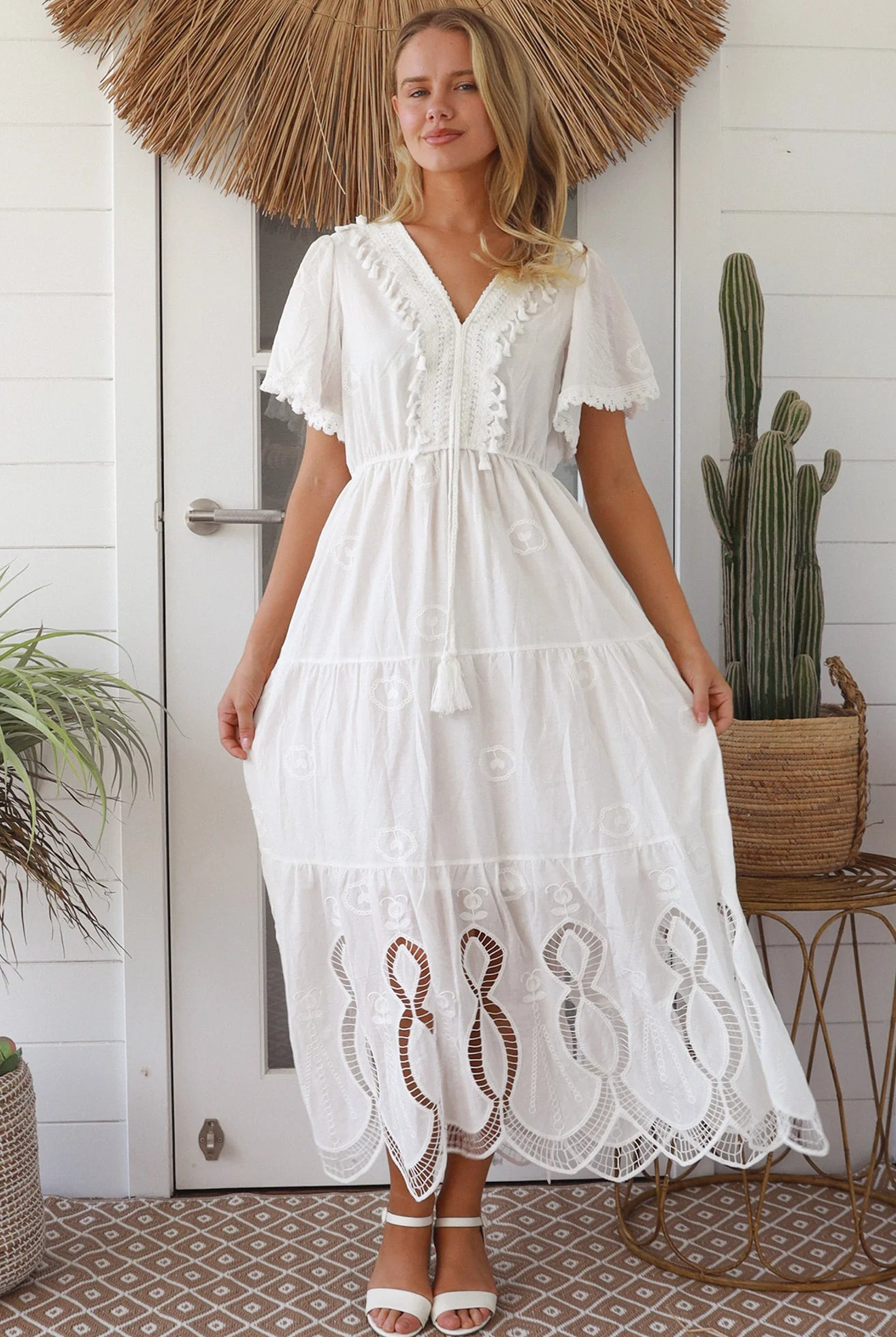 Woman in white embroidered cotton maxi dress with lace sleeves and tiered hem – Boho Maxi Dress Australia