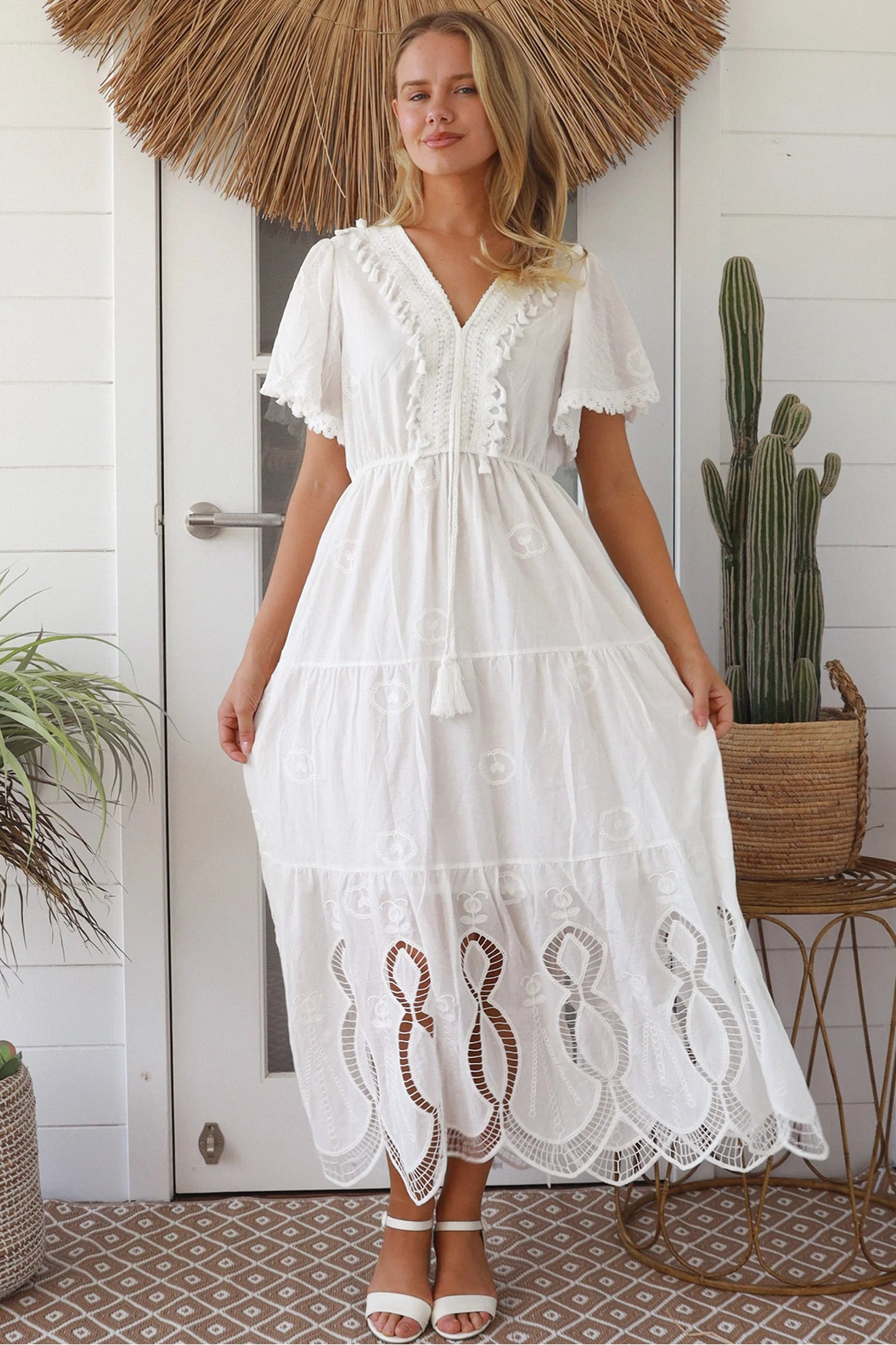 Woman in white embroidered cotton maxi dress with lace sleeves and tiered hem – Boho Maxi Dress Australia