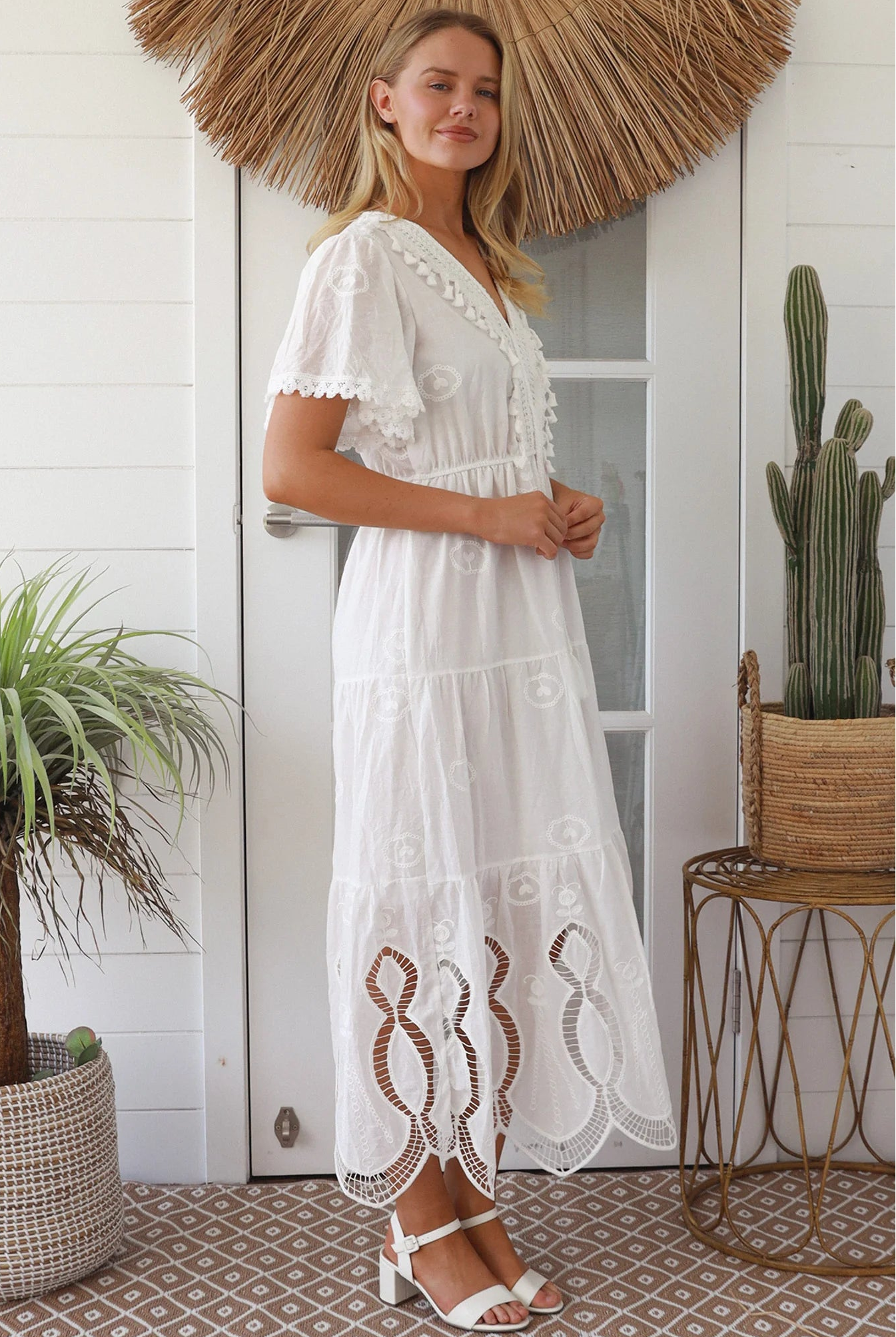 Woman in white embroidered cotton maxi dress with lace sleeves and tiered hem – Boho Maxi Dress Australia