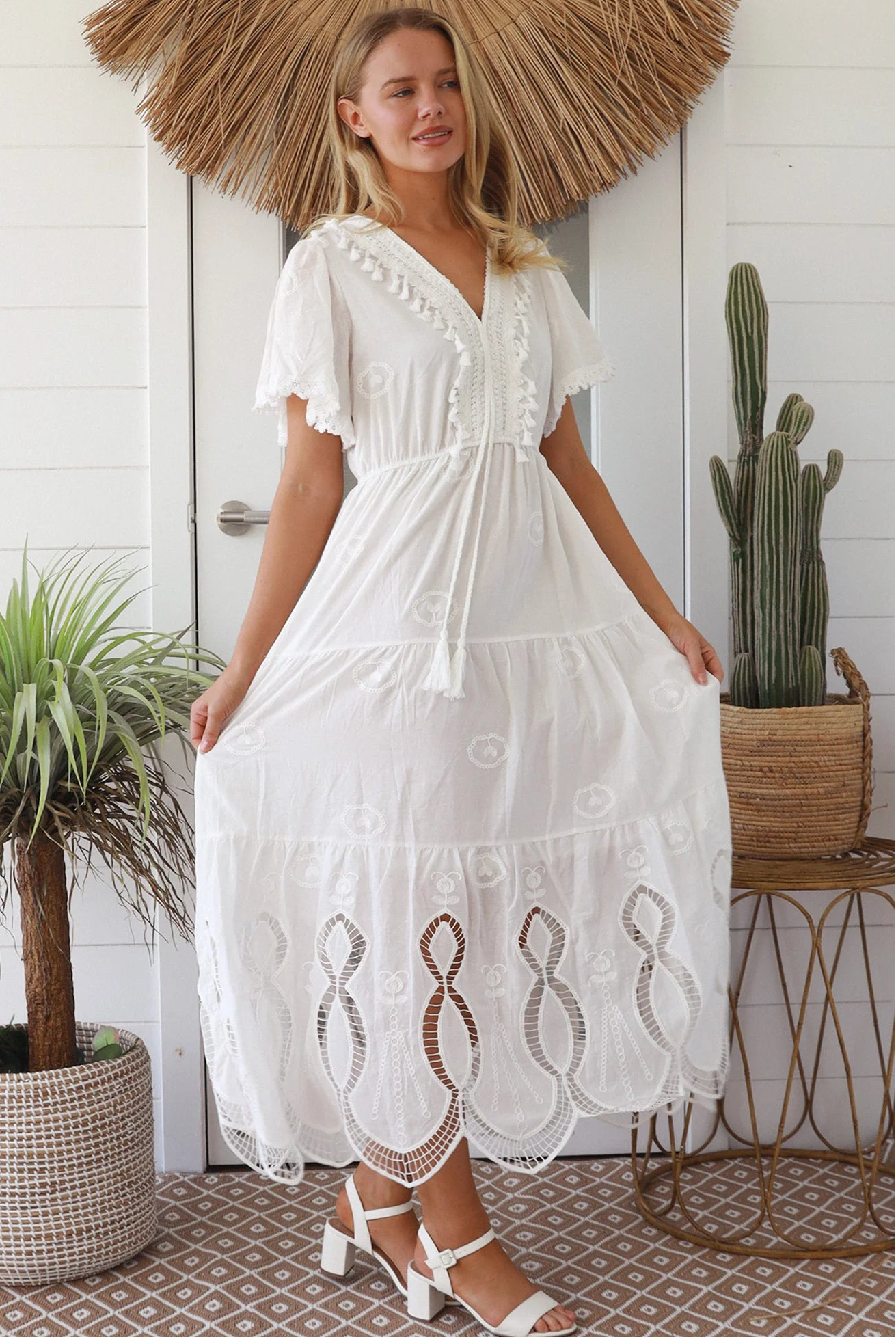 Woman in white embroidered cotton maxi dress with lace sleeves and tiered hem – Boho Maxi Dress Australia