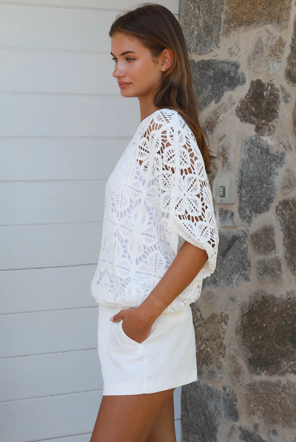 White cotton floral crochet top with kimono sleeves and round neckline styled as an elevated boho layer