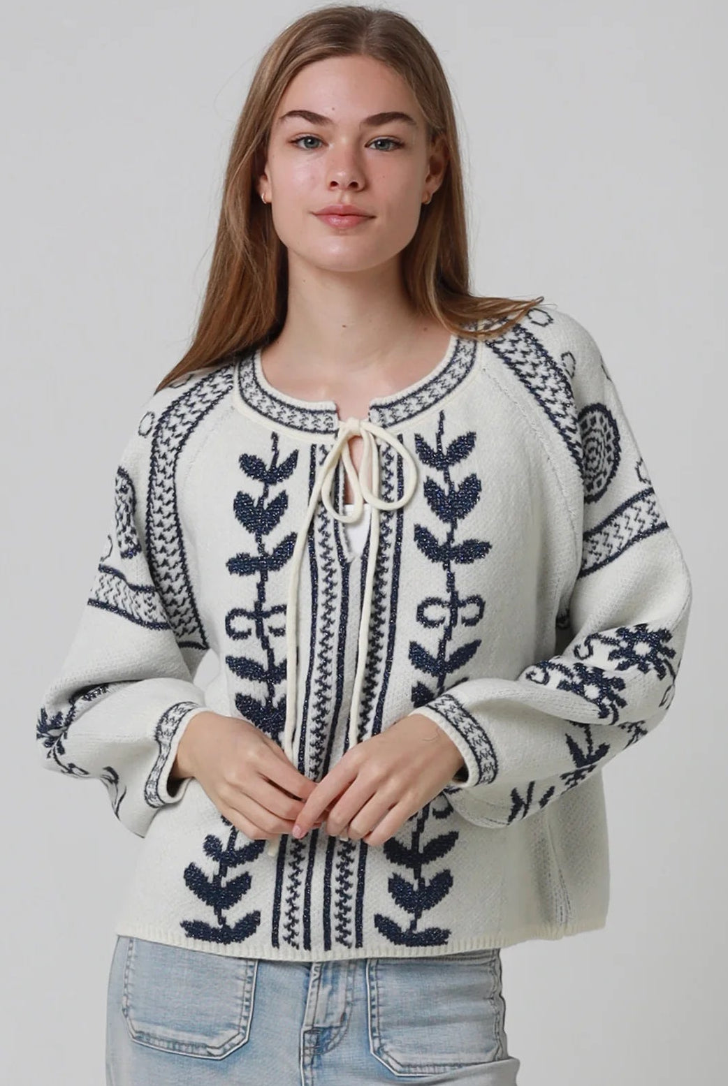Woman wearing cream boho knit jumper with navy lurex detailing balloon sleeves textured winter styling and relaxed bohemian knitwear Australia