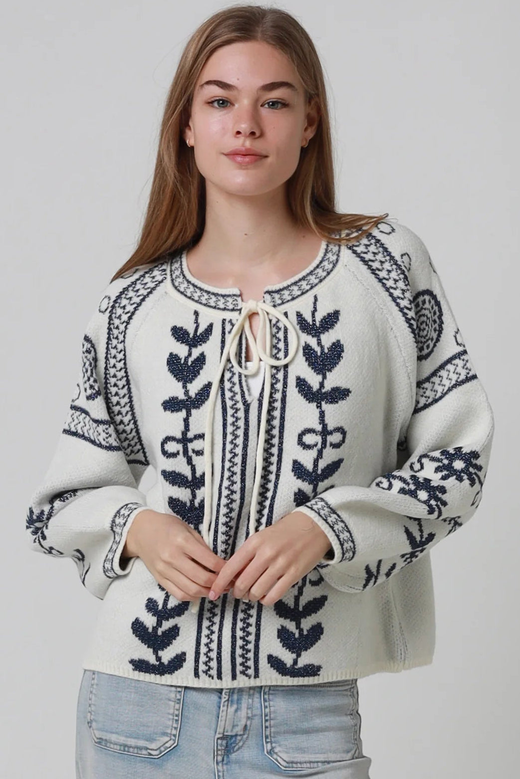Woman wearing cream boho knit jumper with navy lurex detailing balloon sleeves textured winter styling and relaxed bohemian knitwear Australia