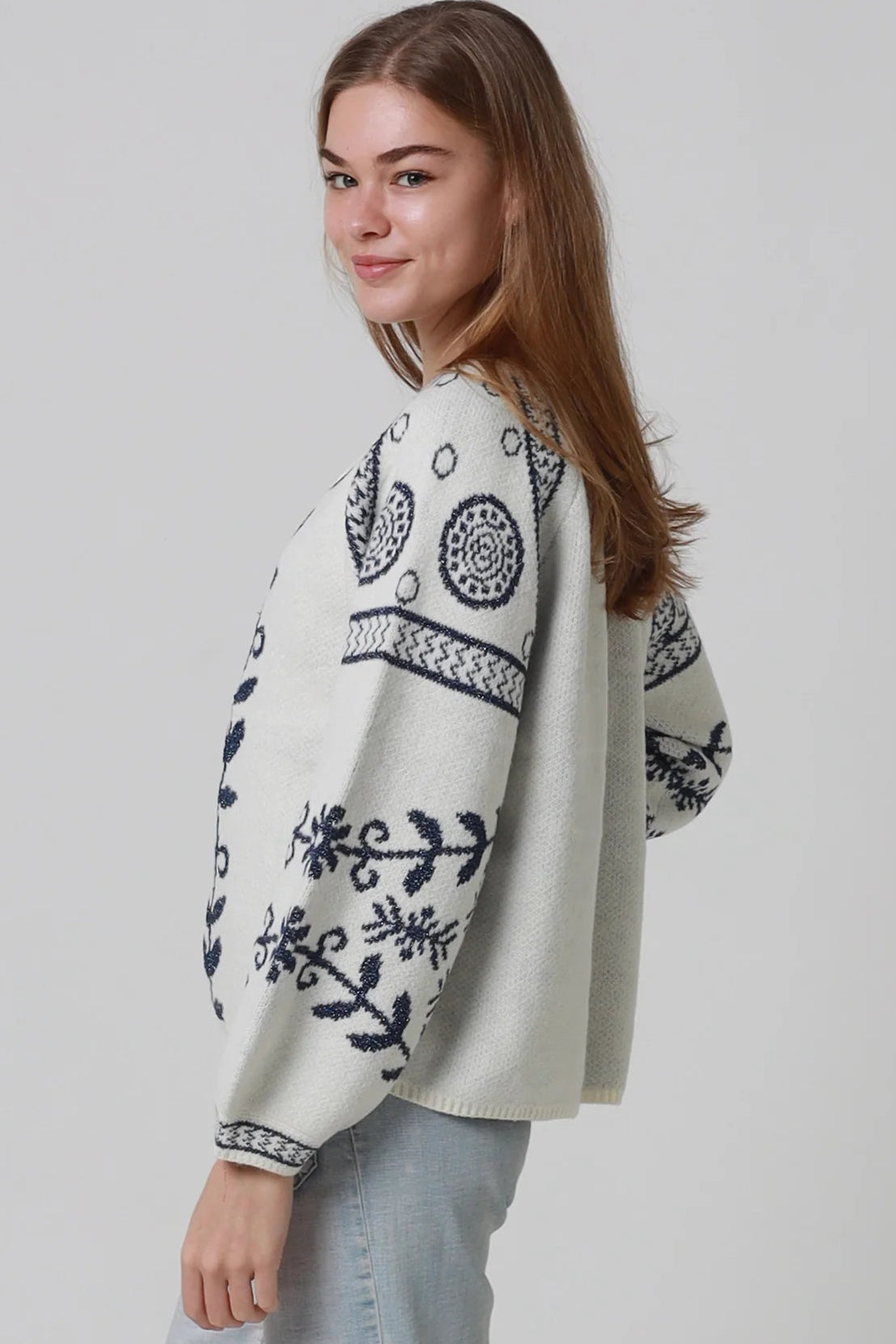 Woman wearing cream boho knit jumper with navy lurex detailing balloon sleeves textured winter styling and relaxed bohemian knitwear Australia