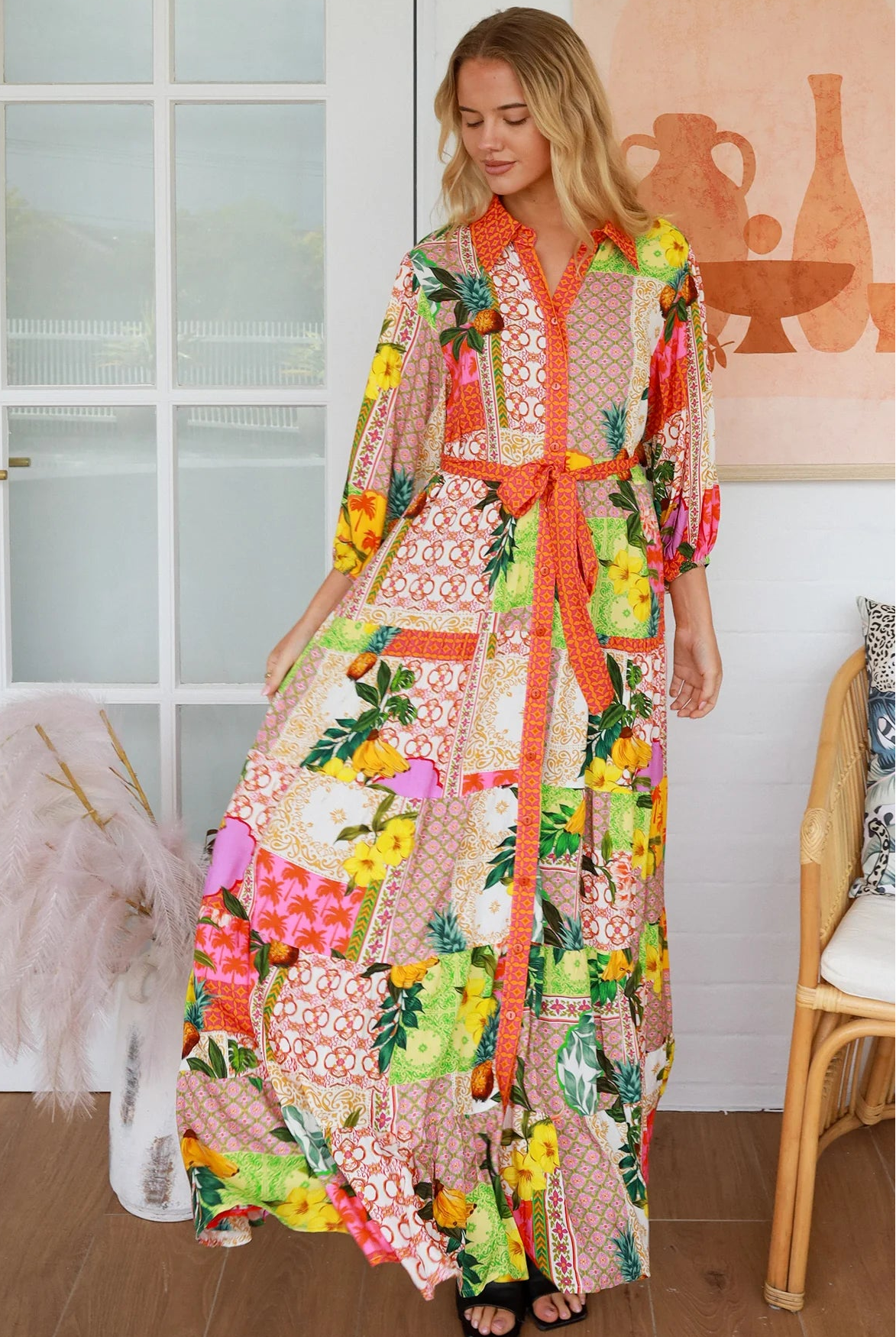 “Woman in tropical patchwork bamboo rayon boho maxi dress with red collar and tie belt — sustainable bohemian fashion Australia.”