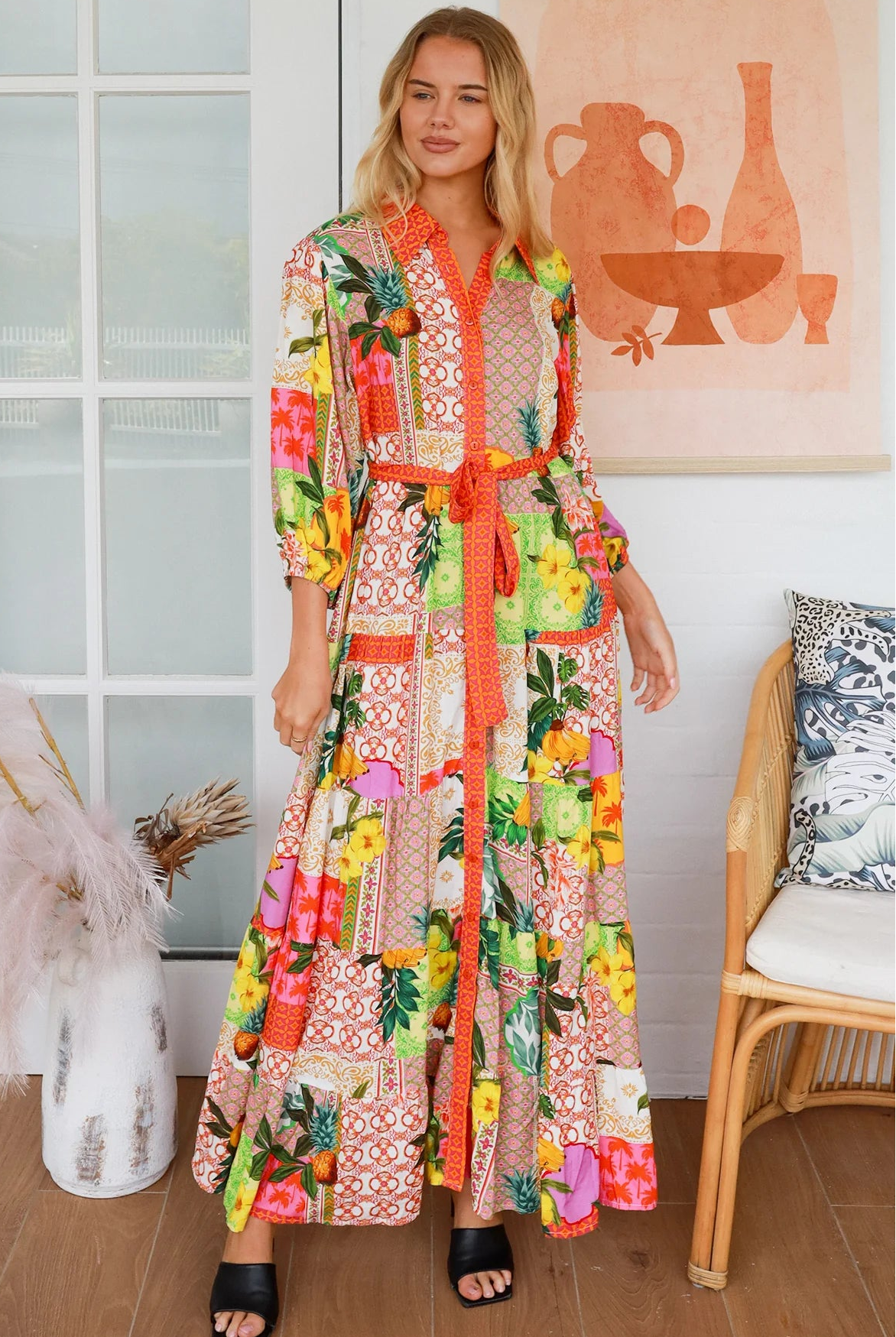 “Woman in tropical patchwork bamboo rayon boho maxi dress with red collar and tie belt — sustainable bohemian fashion Australia.”