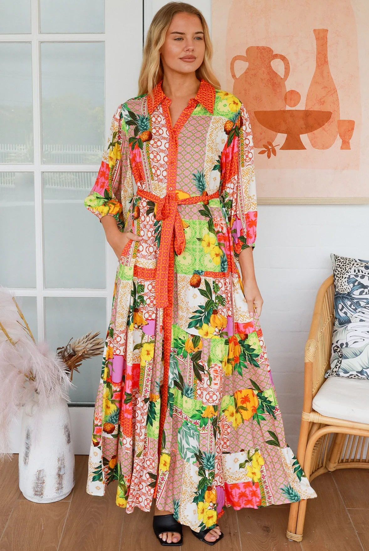 “Woman in tropical patchwork bamboo rayon boho maxi dress with red collar and tie belt — sustainable bohemian fashion Australia.”