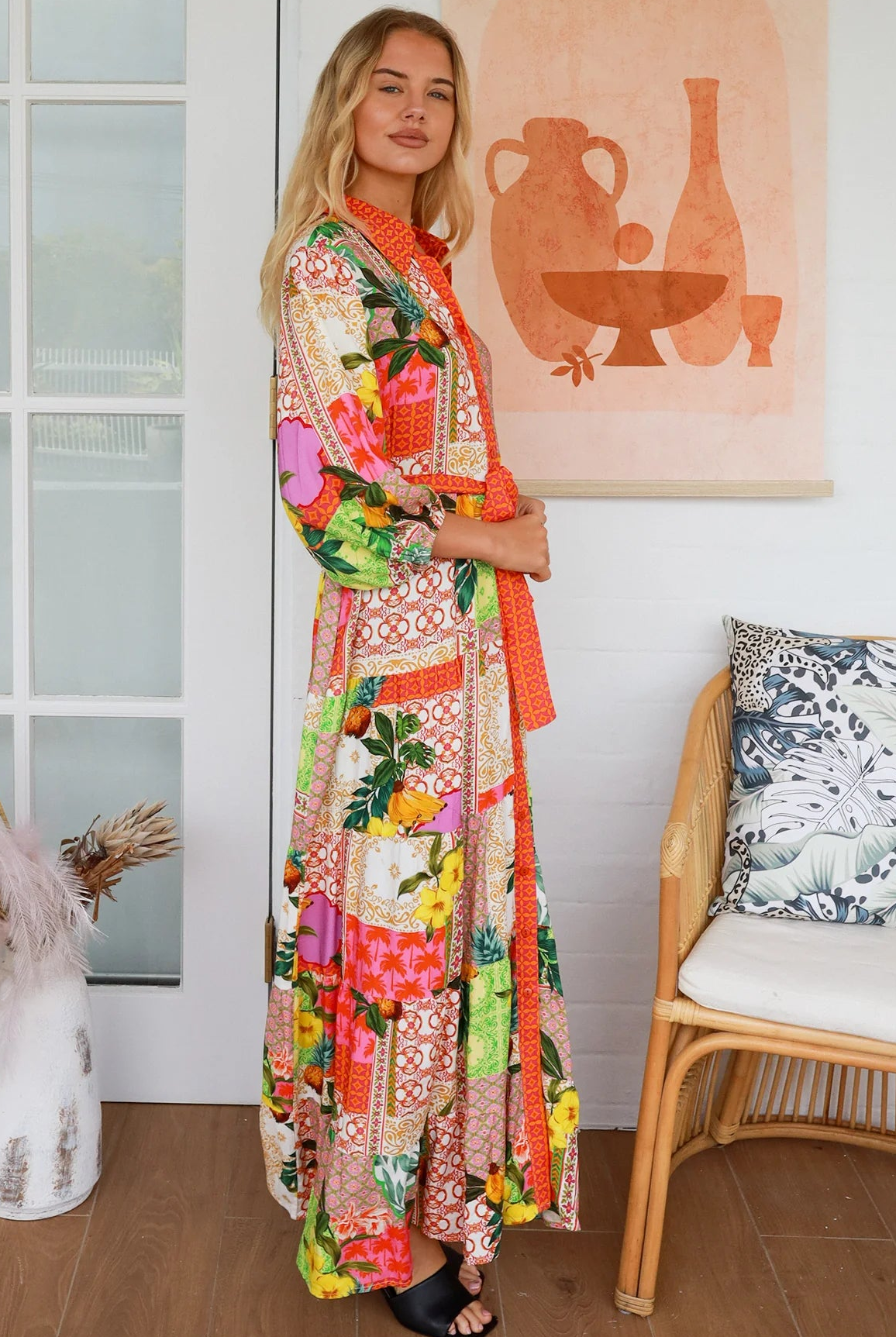 “Woman in tropical patchwork bamboo rayon boho maxi dress with red collar and tie belt — sustainable bohemian fashion Australia.”