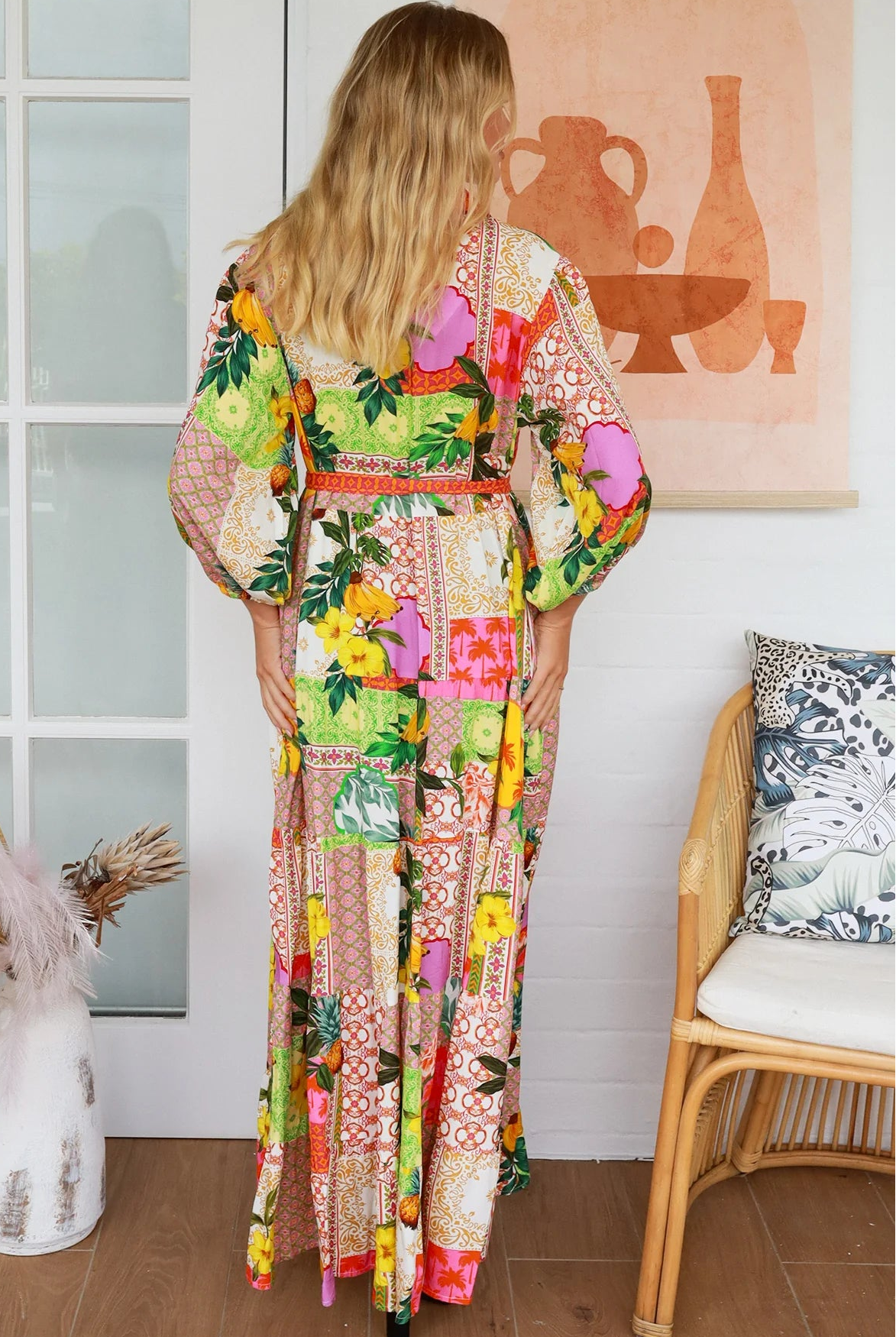 “Woman in tropical patchwork bamboo rayon boho maxi dress with red collar and tie belt — sustainable bohemian fashion Australia.”
