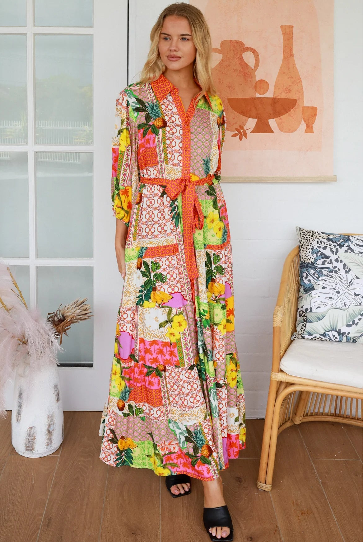 “Woman in tropical patchwork bamboo rayon boho maxi dress with red collar and tie belt — sustainable bohemian fashion Australia.”