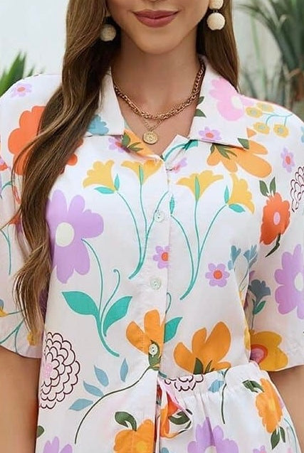 Woman wearing Mutig vintage floral shirt and short set with light base and colourful bohemian print styled for summer