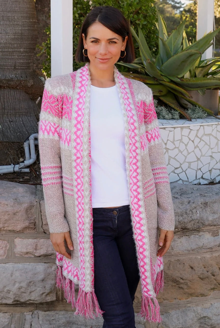 Woman wearing longline rose pink and cream boho knit cardigan with fringe hem - Australian winter fashion.