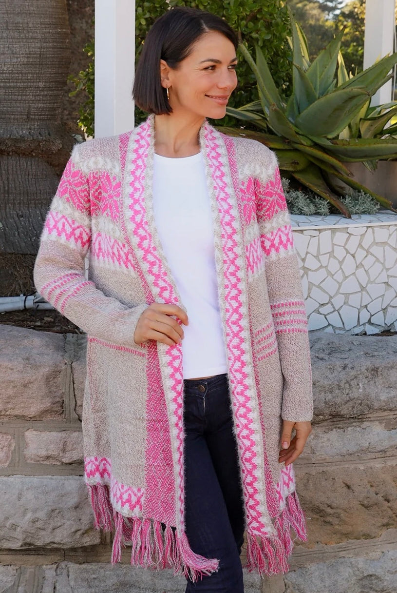 Woman wearing longline rose pink and cream boho knit cardigan with fringe hem - Australian winter fashion.