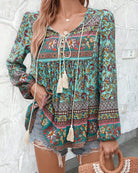 Woman in a vintage turquoise floral boho blouse with long peasant sleeves and tassel ties - The Jasmine Road Top Australia.