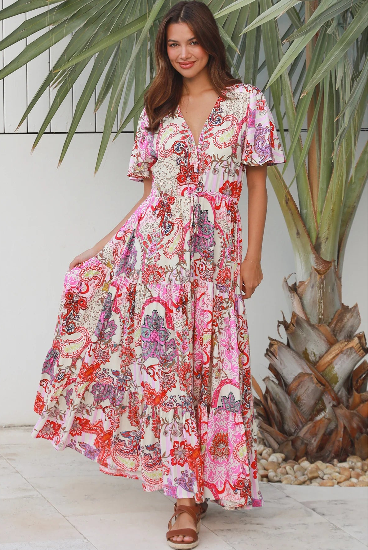 Pink paisley bohemian maxi dress with flutter sleeves, drawstring waist and tiered hem in softly draped rayon. Boho Dresses Australia.