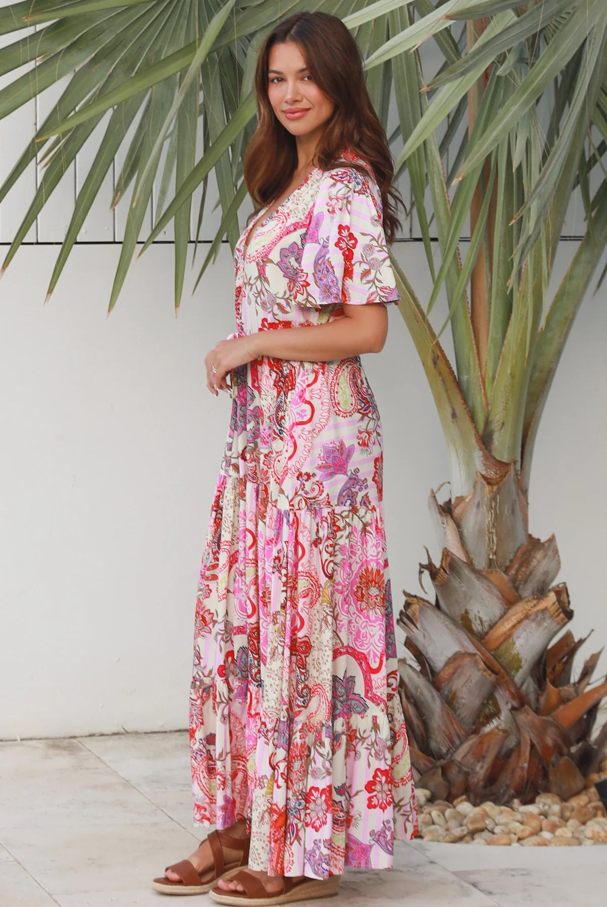 Pink paisley bohemian maxi dress with flutter sleeves, drawstring waist and tiered hem in softly draped rayon. Boho Dresses Australia.