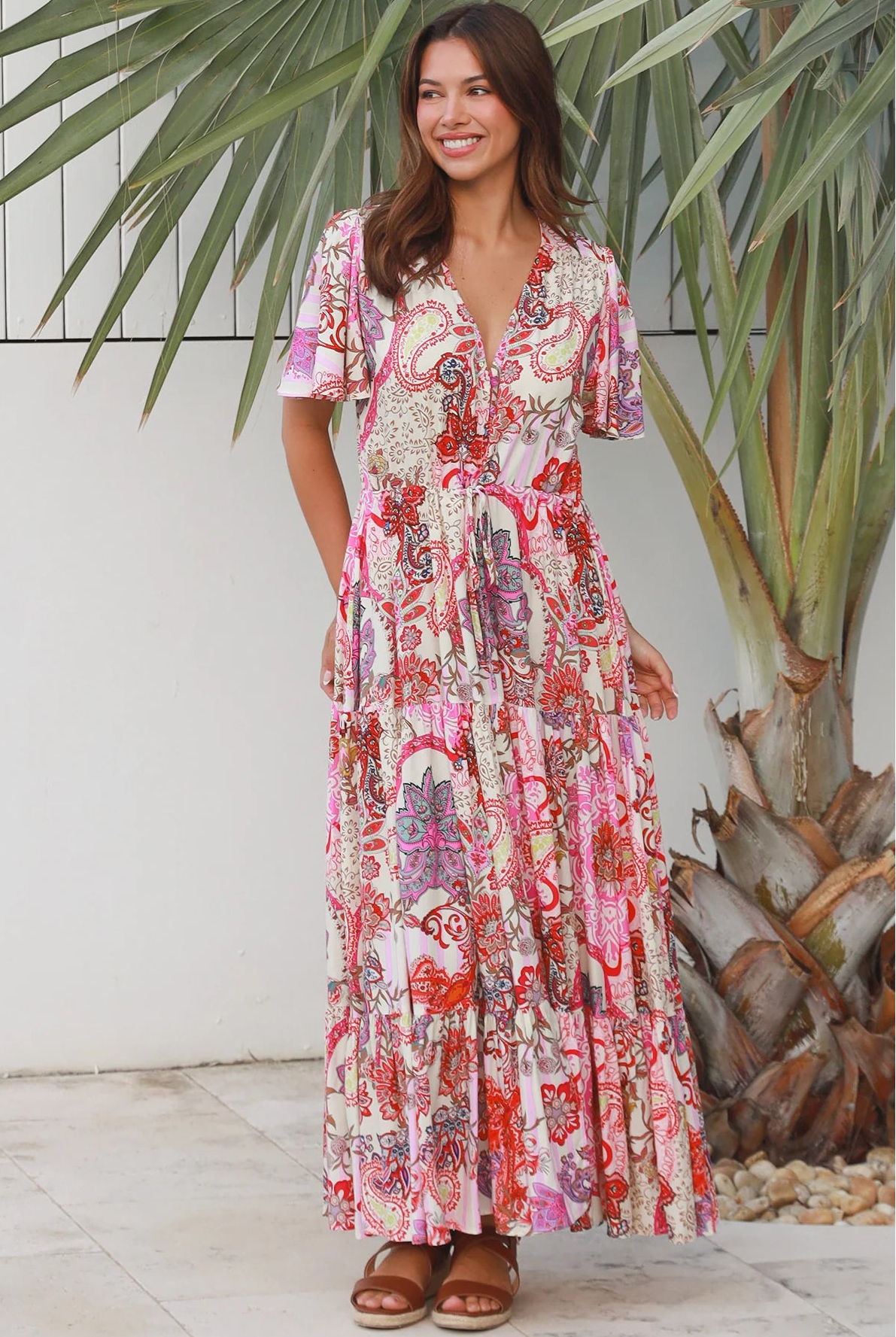 Pink paisley bohemian maxi dress with flutter sleeves, drawstring waist and tiered hem in softly draped rayon. Boho Dresses Australia.