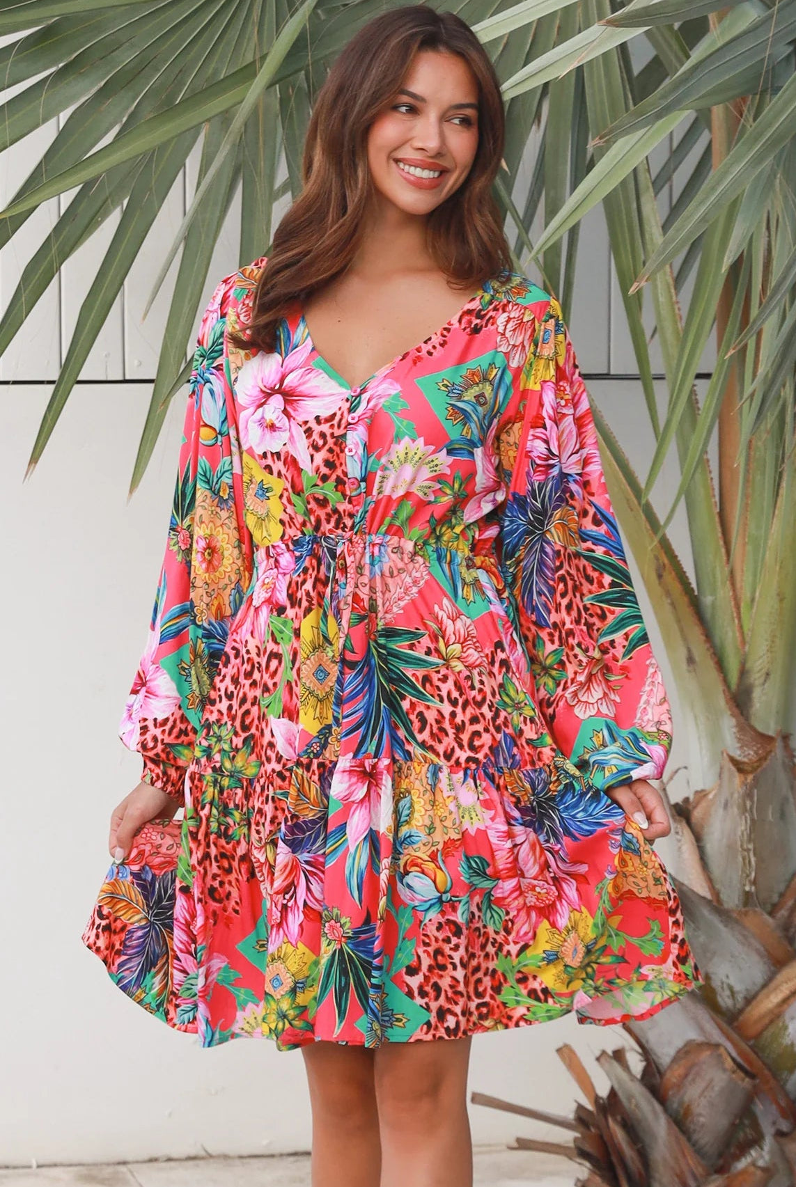 Woman wearing a jungle floral rayon above knee mini dress with blouson sleeves by Dreamcatcher in Australia