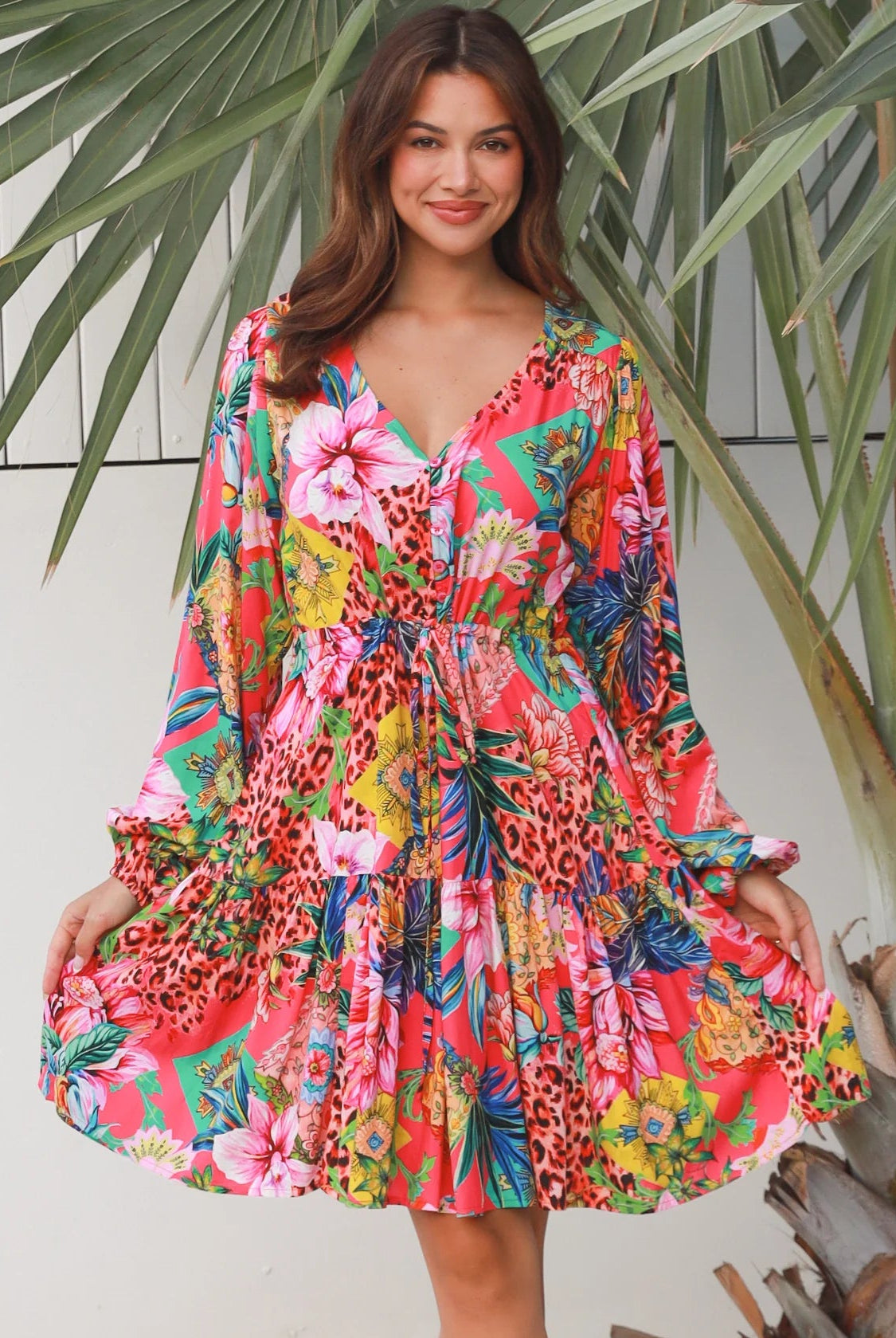 Woman wearing a jungle floral rayon above knee mini dress with blouson sleeves by Dreamcatcher in Australia