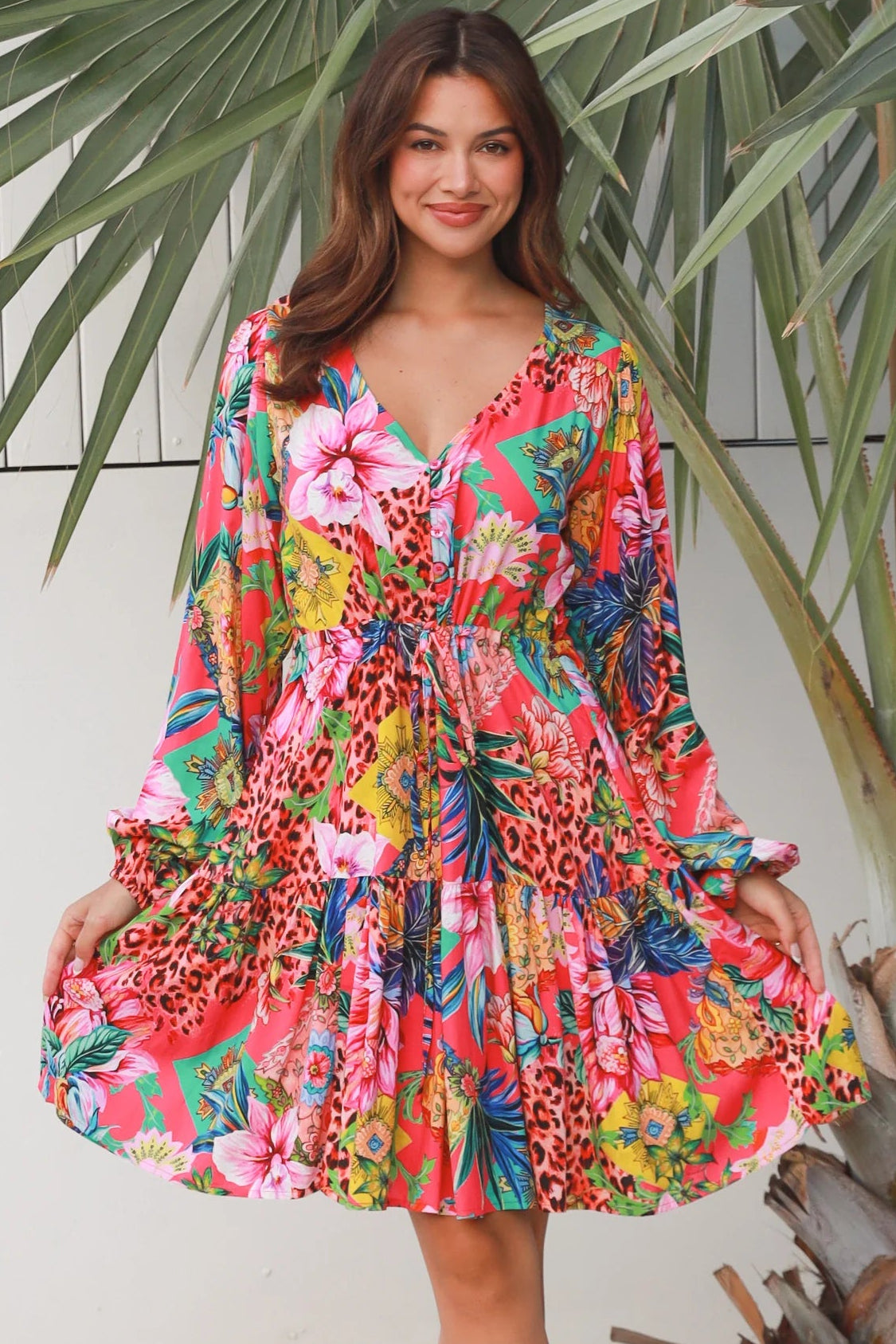 Woman wearing a jungle floral rayon above knee mini dress with blouson sleeves by Dreamcatcher in Australia