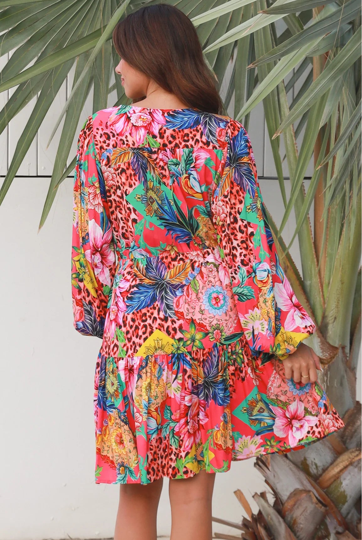 Woman wearing a jungle floral rayon above knee mini dress with blouson sleeves by Dreamcatcher in Australia