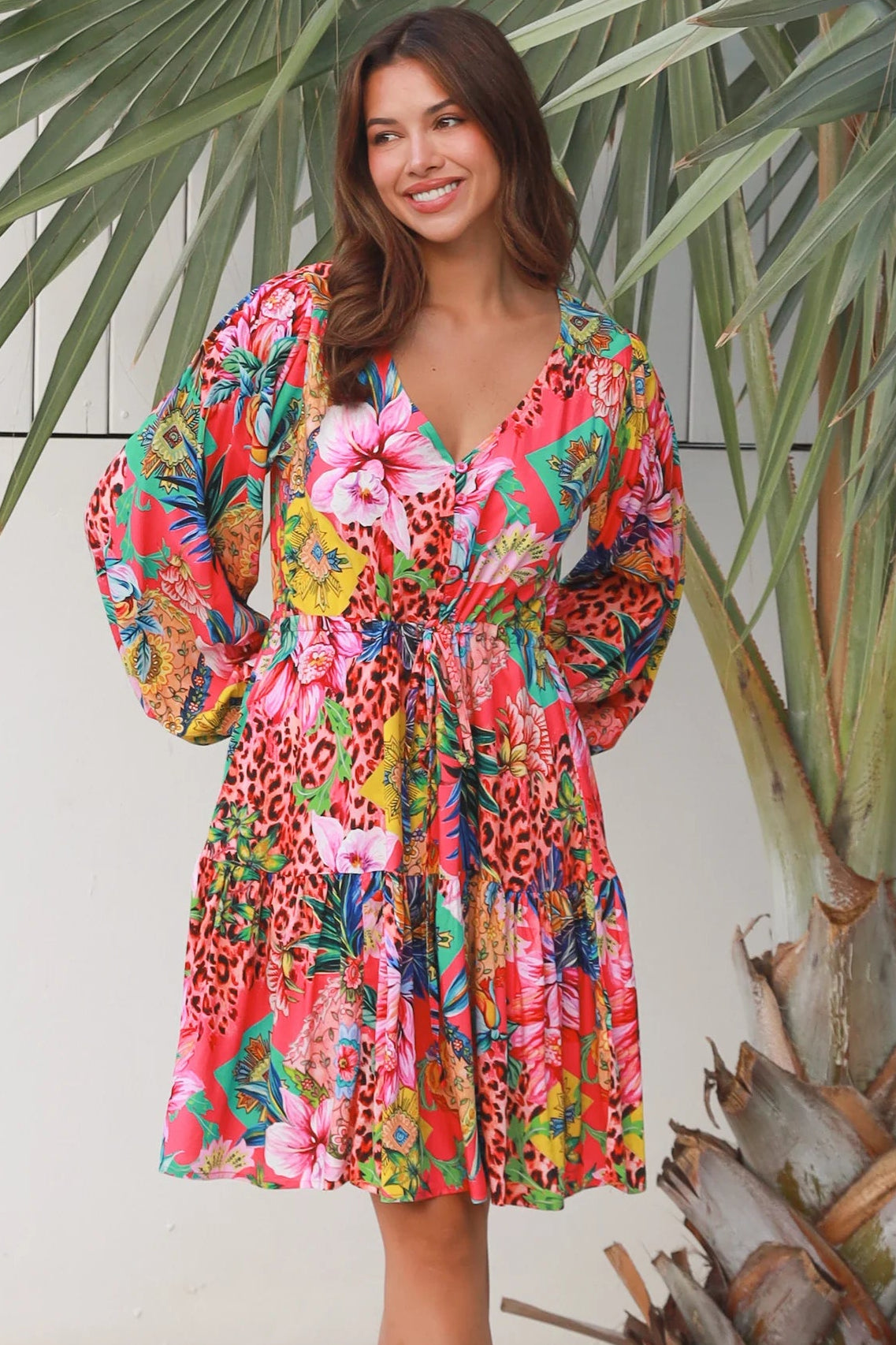 Woman wearing a jungle floral rayon above knee mini dress with blouson sleeves by Dreamcatcher in Australia