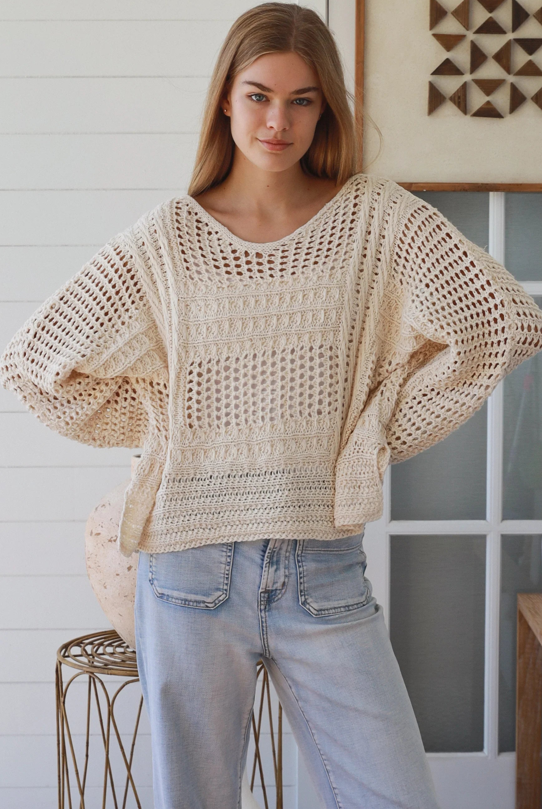 Cream crochet knit sweater with open weave relaxed fit boho top Australia styled with light wash denim jeans
