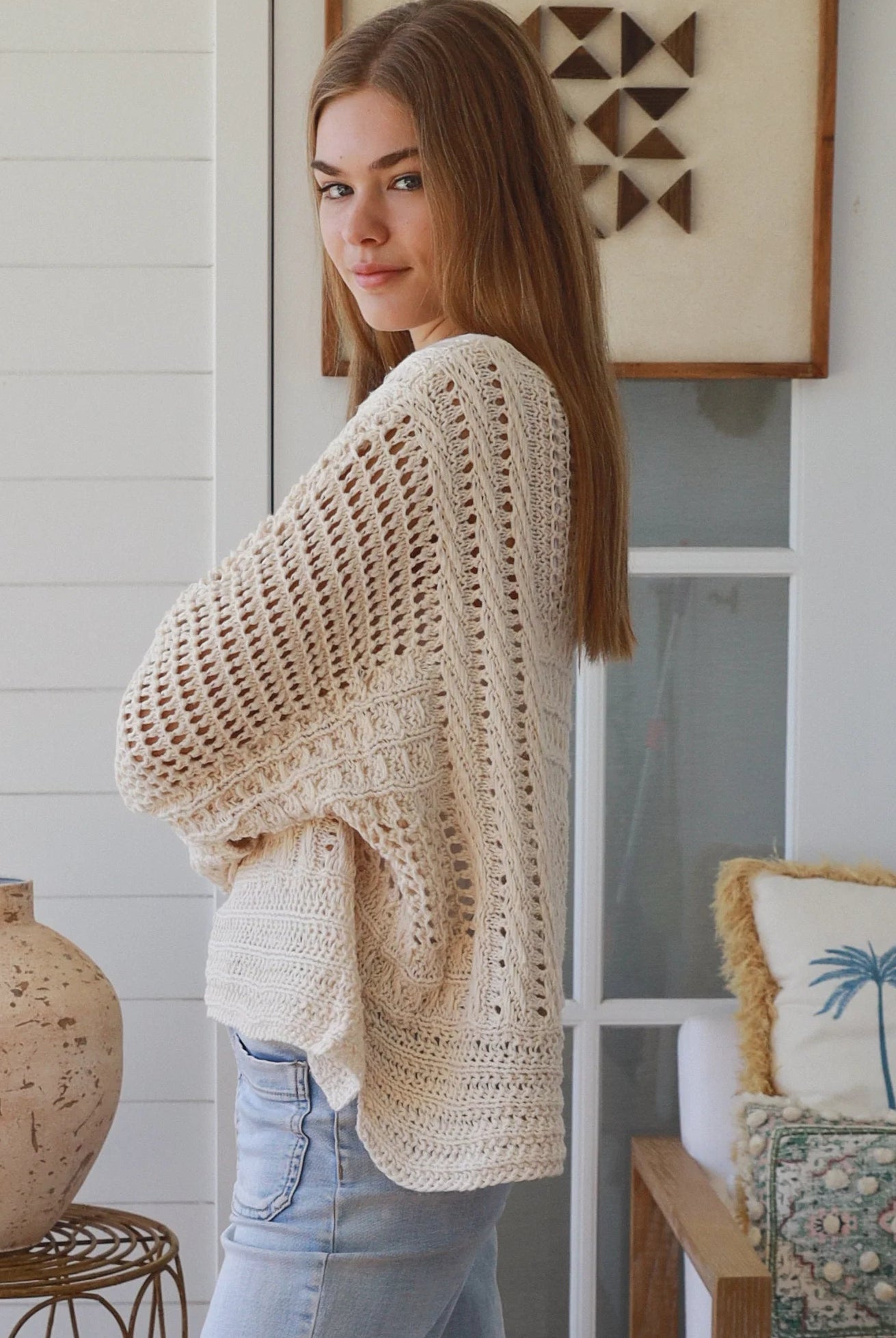 Cream crochet knit sweater with open weave relaxed fit boho top Australia styled with light wash denim jeans