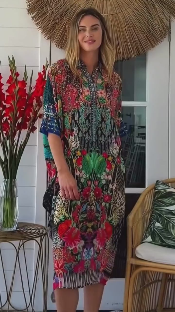 Woman in the Havana Bloom kaftan midi dress walking through a sunlit room surrounded by tropical florals -bohemian resort fashion Australia