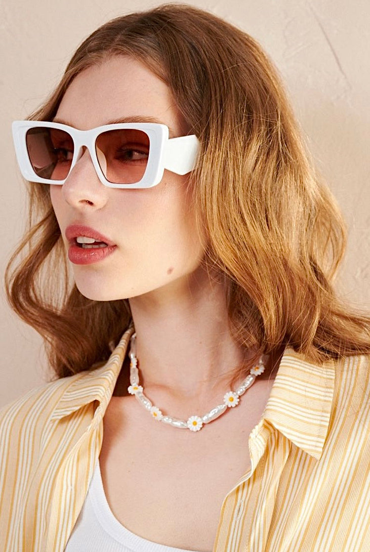 Women in square retro sunglasses with loose waves and yellow shirt—soft vintage boho look Australia.