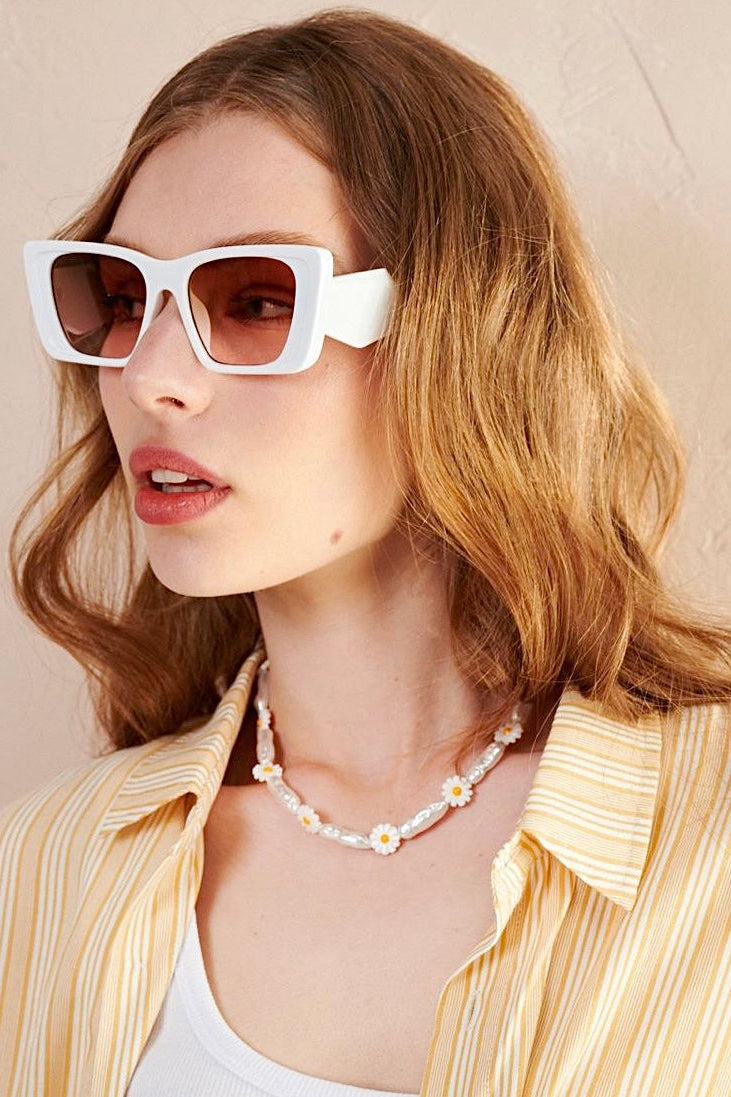 Women in square retro sunglasses with loose waves and yellow shirt—soft vintage boho look Australia.