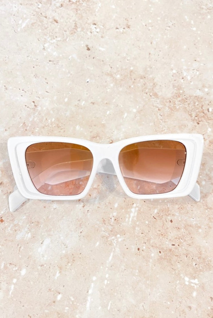 Women in square retro sunglasses with loose waves and yellow shirt—soft vintage boho look Australia.