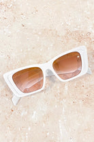 Women in square retro sunglasses with loose waves and yellow shirt—soft vintage boho look Australia.