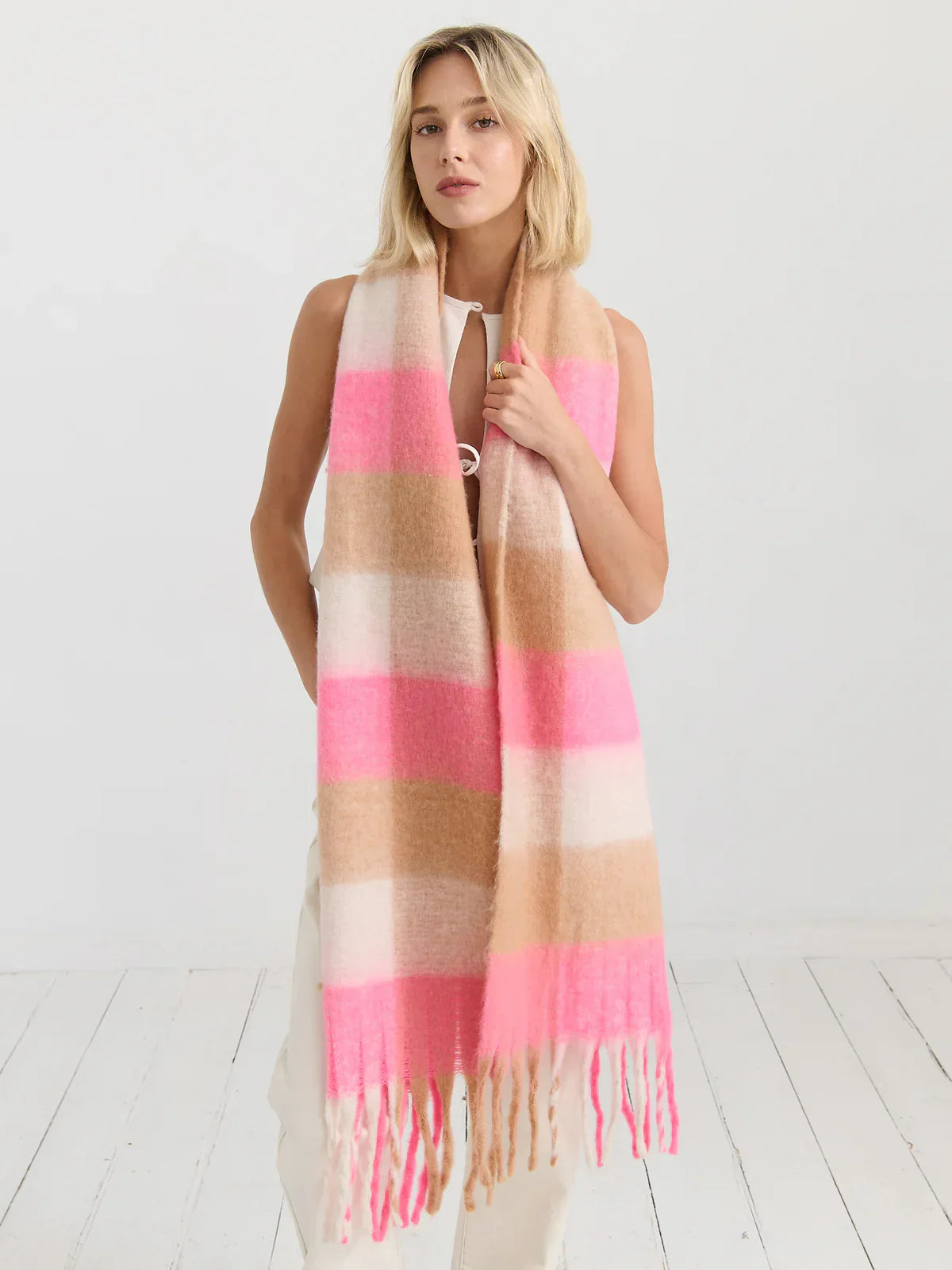 Woman wrapped in a boho winer scarf in blush and caramel - soft knit sayers for cold days in Australia.