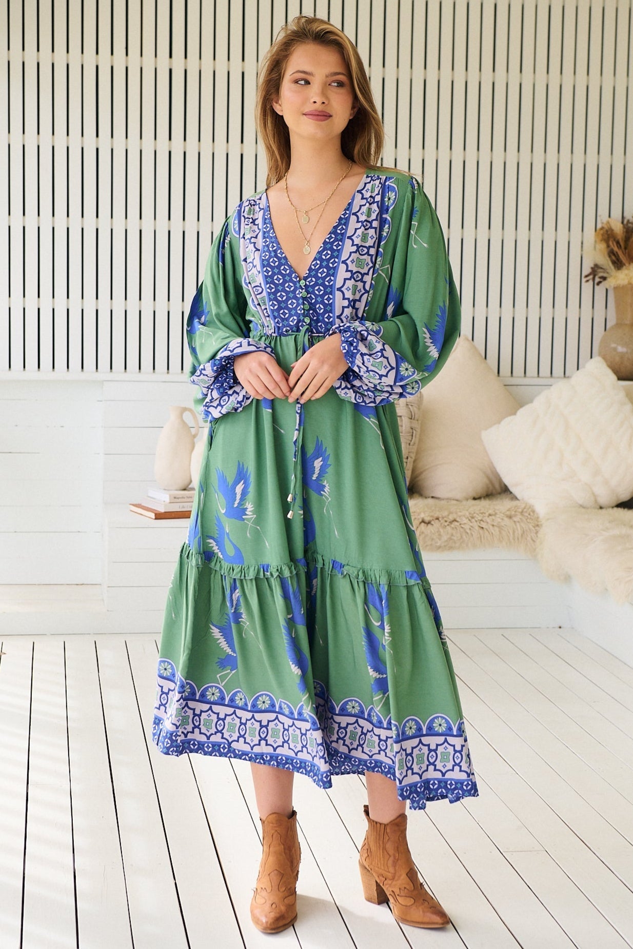 Model wearing a flowy bohemian dress with soft fabric and romantic floral print, free spirited, feminine style.