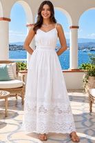 Lola white embroidered cotton maxi dress by Salty Palm featuring floral cutwork, adjustable straps, fitted waist and scalloped lace hem.