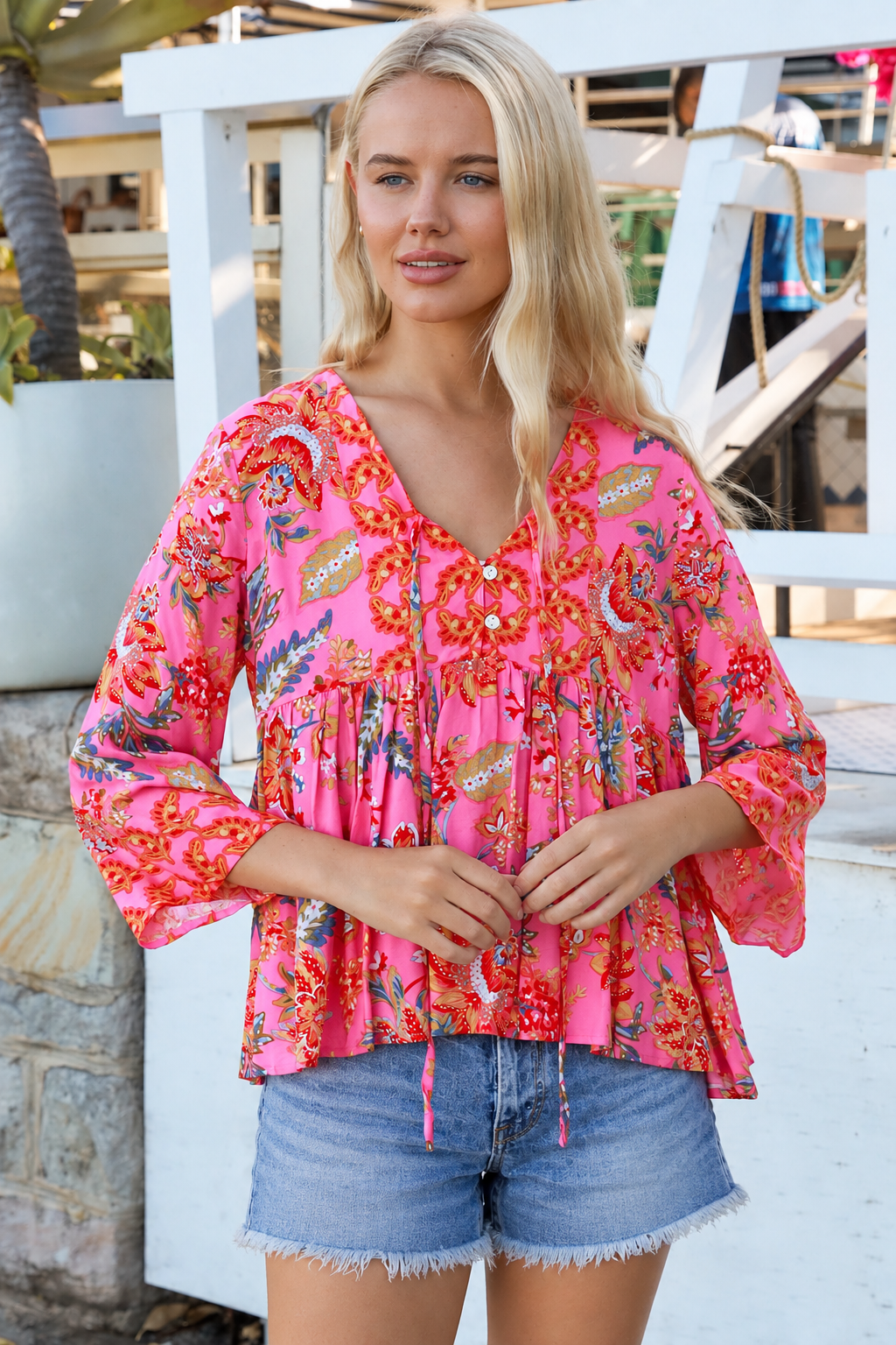 Sintra pink floral boho top with V-neck, button front, ties and three-quarter bell sleeves